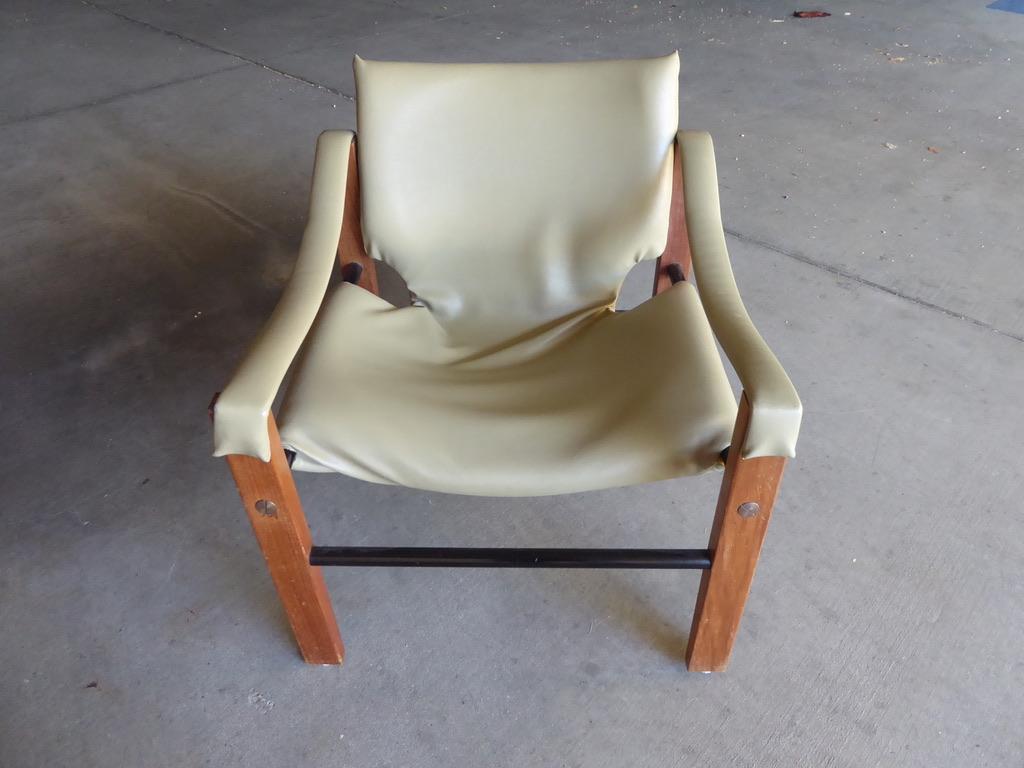 A 1970s teak and beige leather safari chair by Maurice Burke for Arkana. Made in Bath, England.