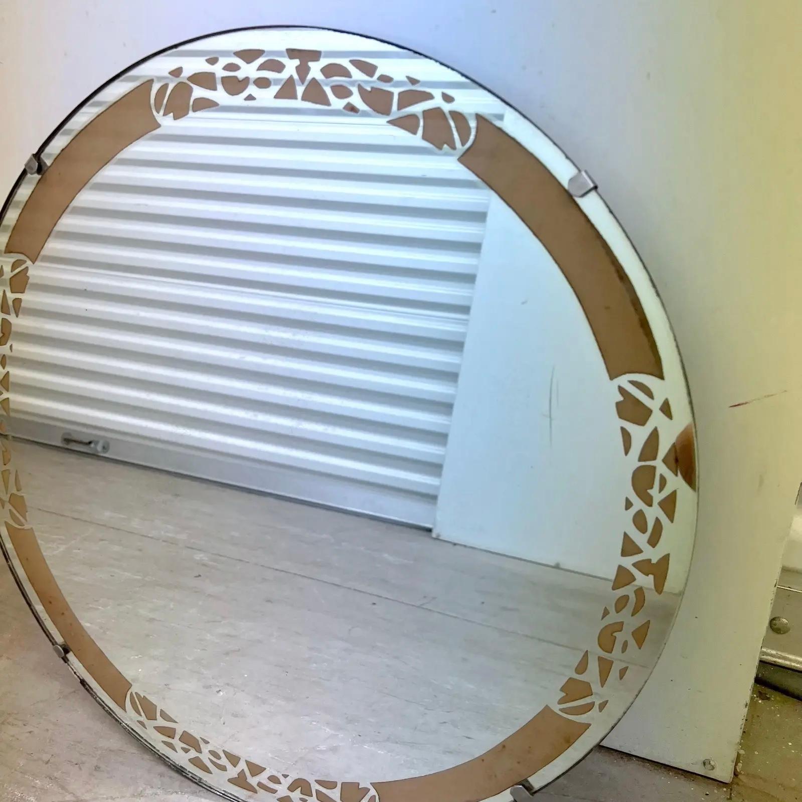 A fantastic round vintage Art Deco mirror with a rose gold decorative painted boarder.  C. Late 1970- early 1980’s 