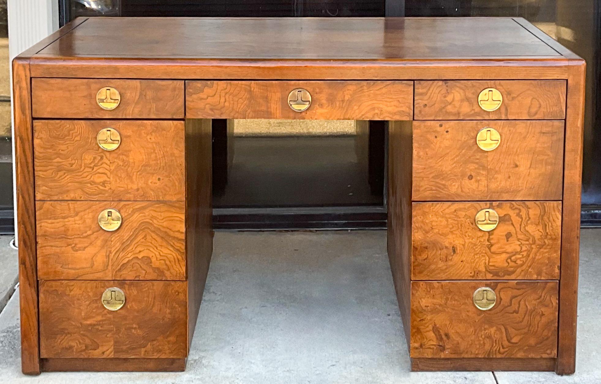 This is a handsome Art Deco style patchwork burl desk designed by Robert Caldwell for Sligh. The modern brass campaign inspired hardware is original.. The left side has a file drawer. The desk is marked.