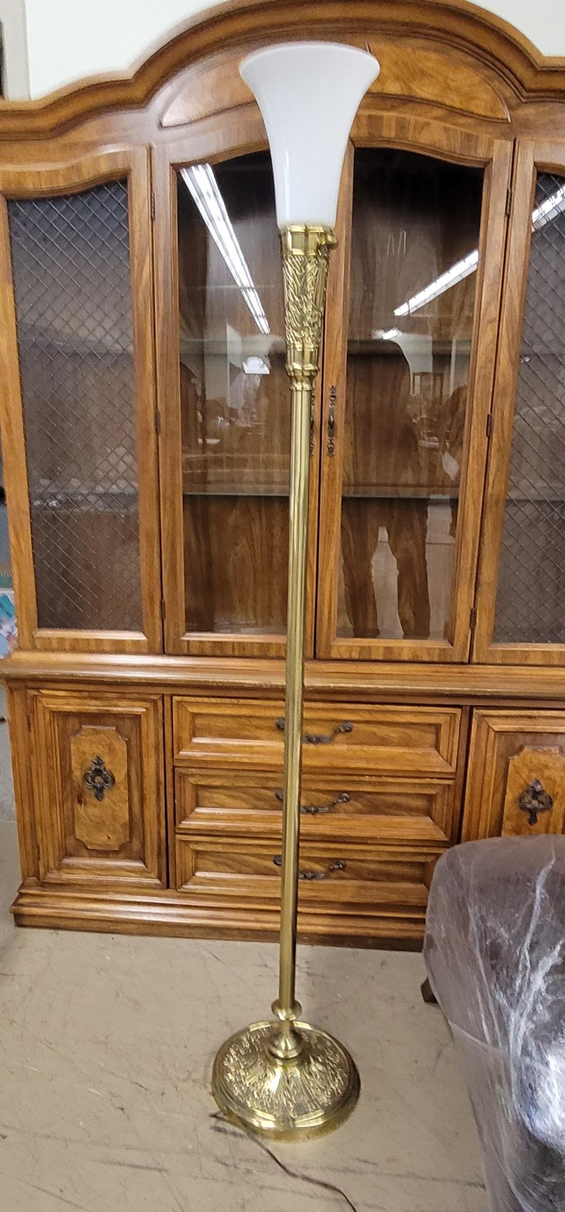 A 69 inches tall carved brass Torchiere floor lamp with original milk glass shade by Stifel.
Measures 11