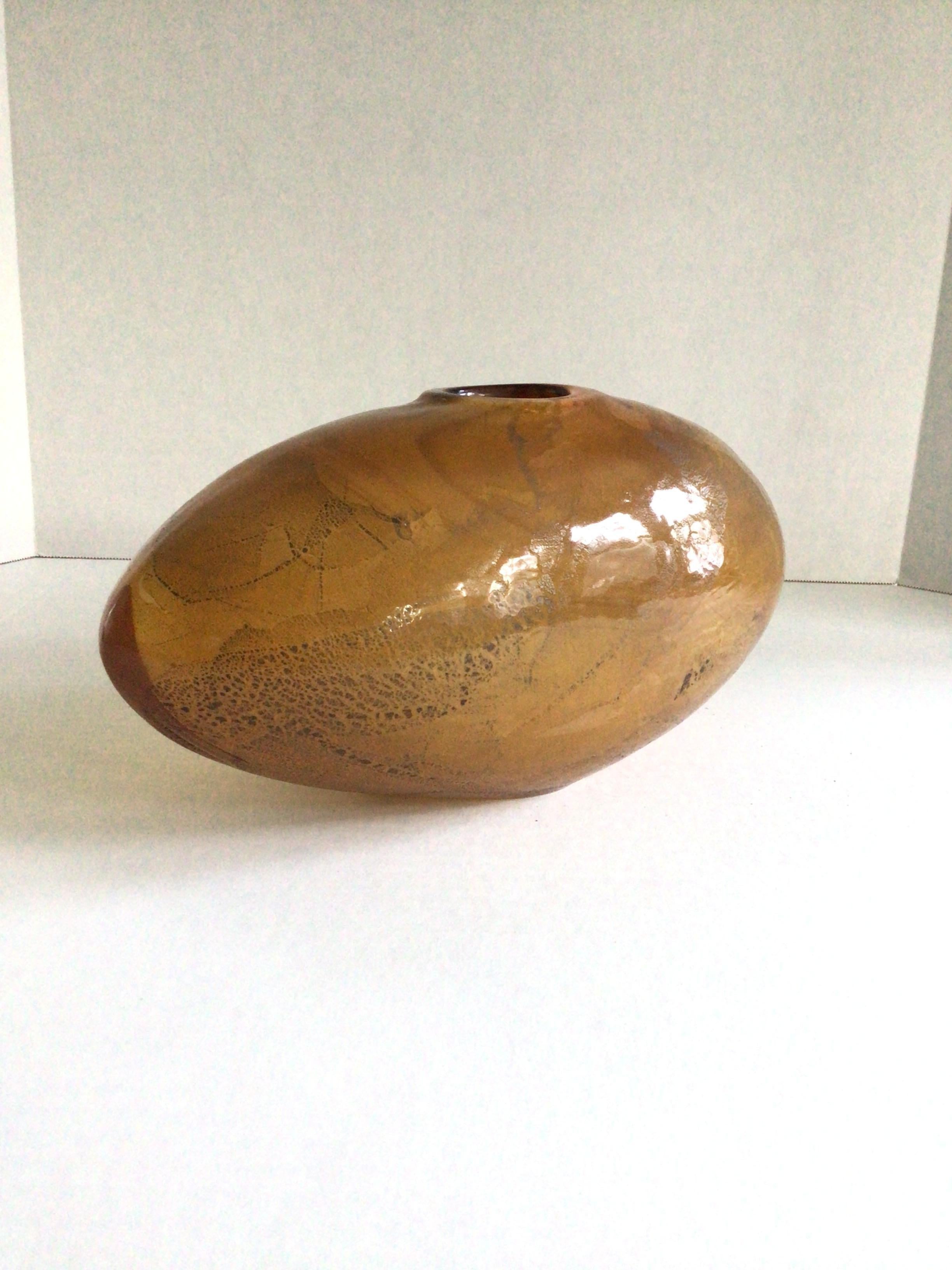 Ce vase en verre d'art soufflé à la main dans les années 1970, avec un fond fumumé doré, est doté d'un trou central et constitue un bel accessoire pour une variété de styles d'intérieur.