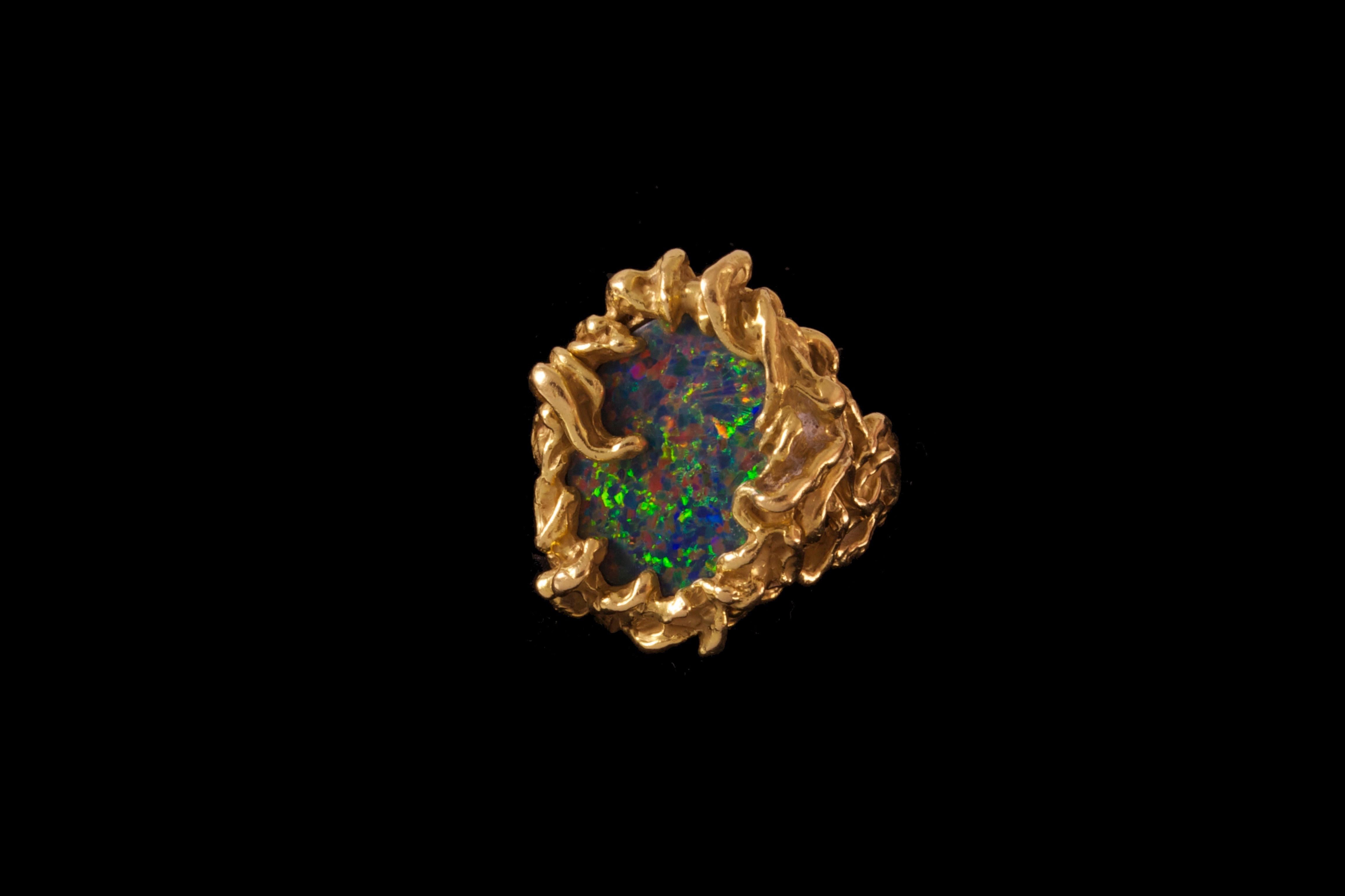 A unique, black opal and 18 karat gold ring, by American independent jeweler and goldsmith Arthur King, 1970s. The ring is a size 7.5. It measures 1.2