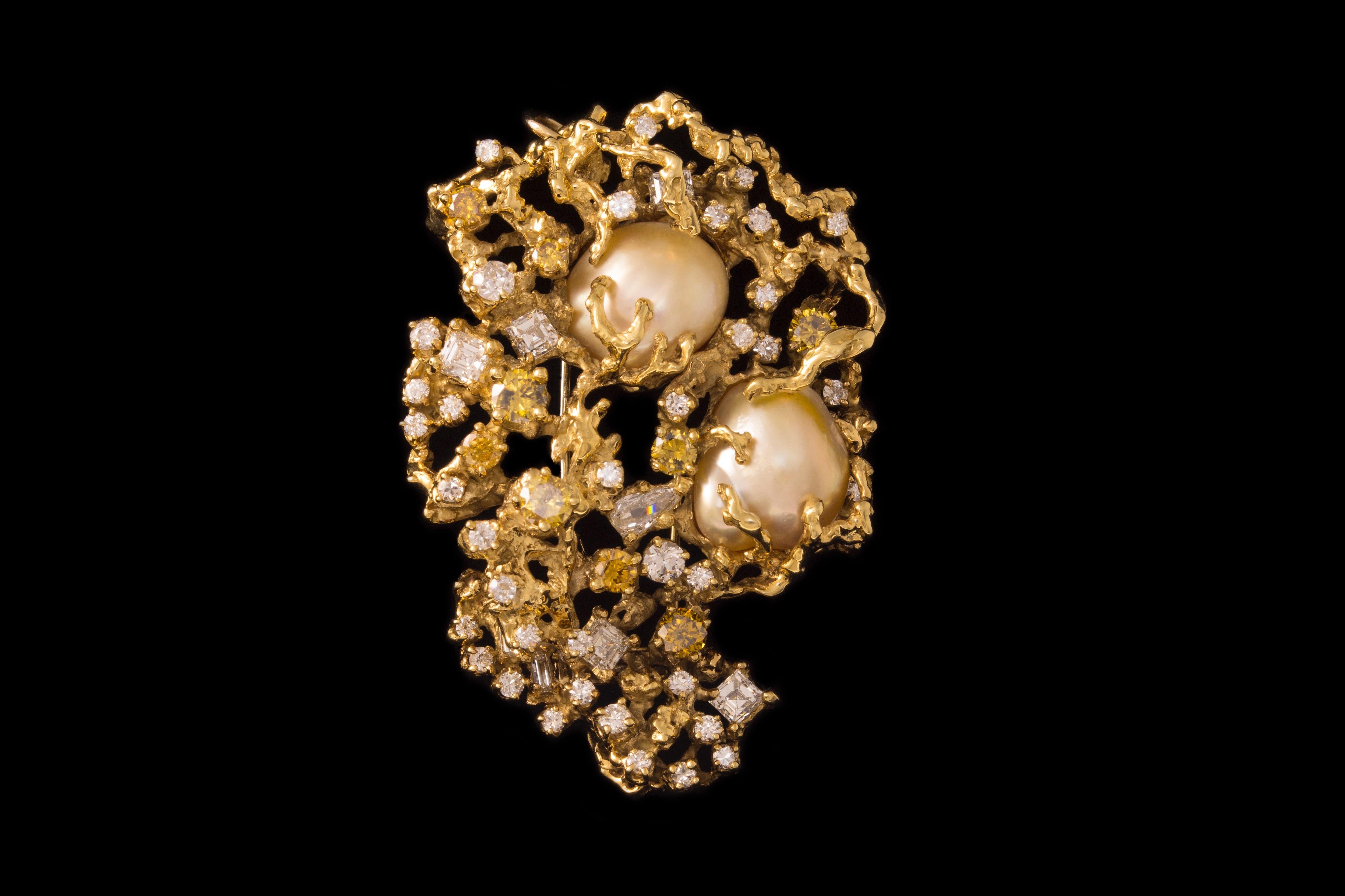 A baroque south sea pearl, white and colored diamonds, and 18 karat gold brooch/pendant, by Arthur King, 1970s. Vintage jewelry. This brooch measures 2.56