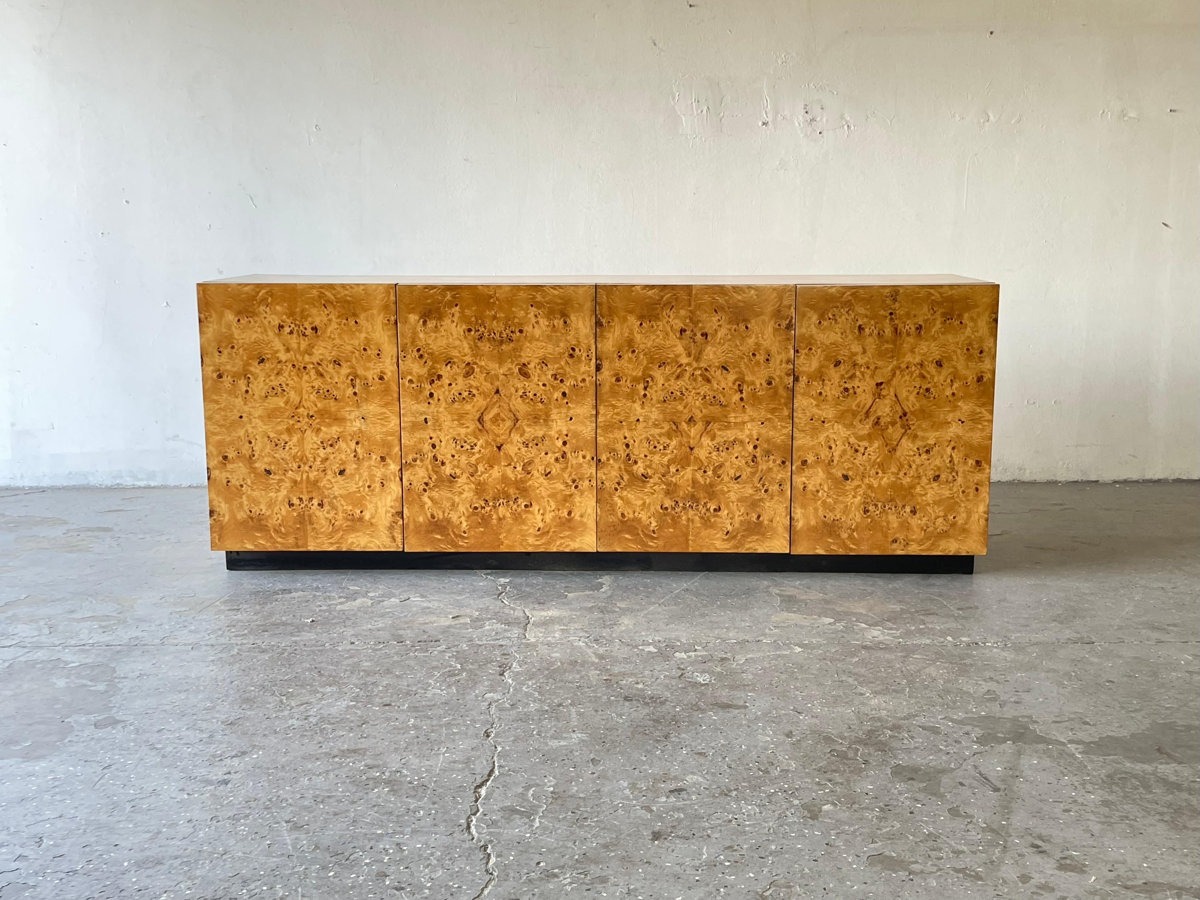 1970s Arthur Umanoff for Dillingham Olive Burl wood Credenza
Minimalist modern credenza in burled olive wood by Arthur Umanoff for Dillingham circa 1970s. Credenza rests on a black plinth base. Gorgeous highly figured burl grain