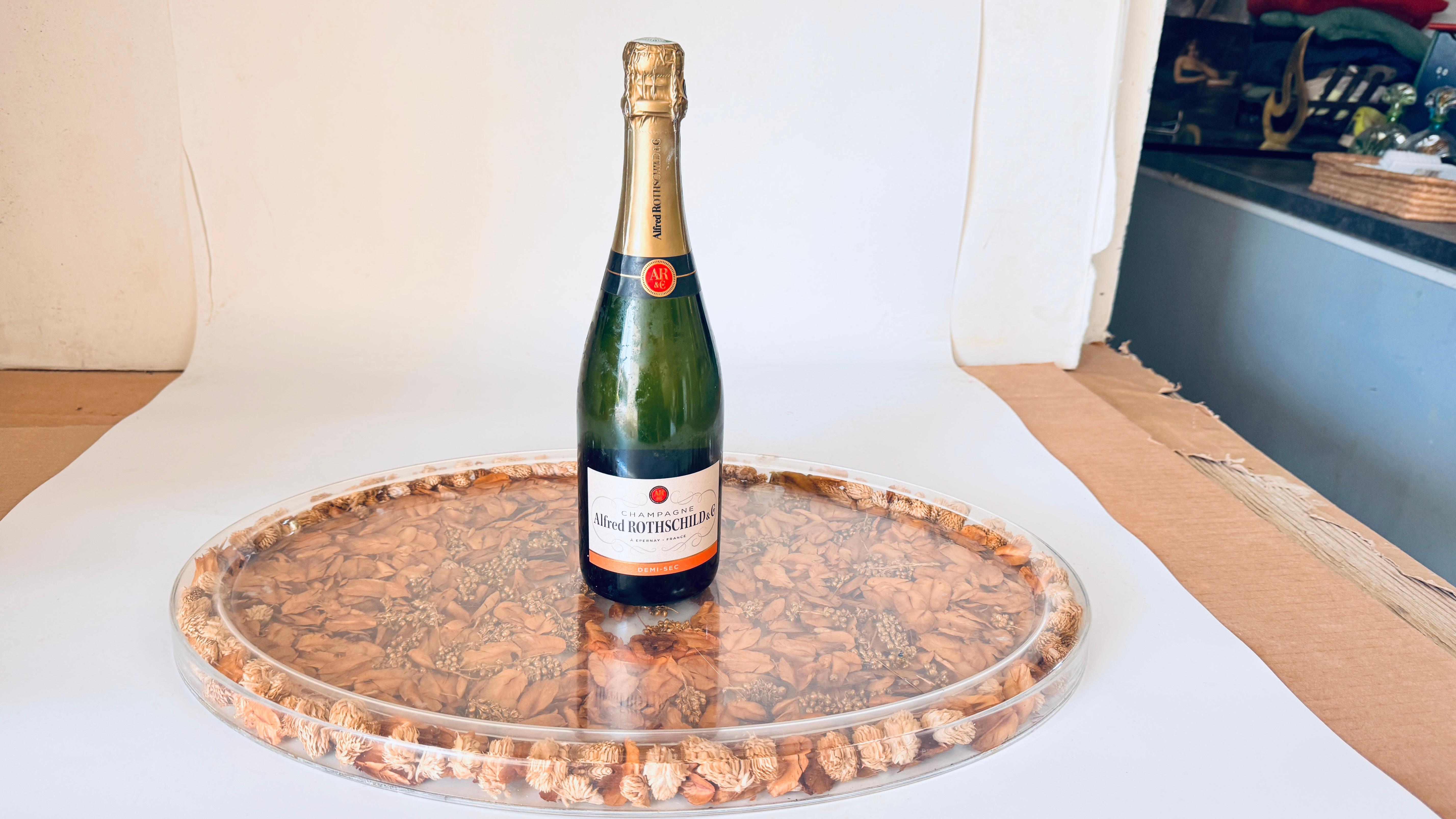 1970s Asian Hard Plastic Tray with Embedded Dried Flowers and Leaves, Oval Shape

This vintage 1970s tray, crafted in Asia, is a beautifully designed hard plastic piece featuring real dried flowers and leaves embedded within its surface. With its