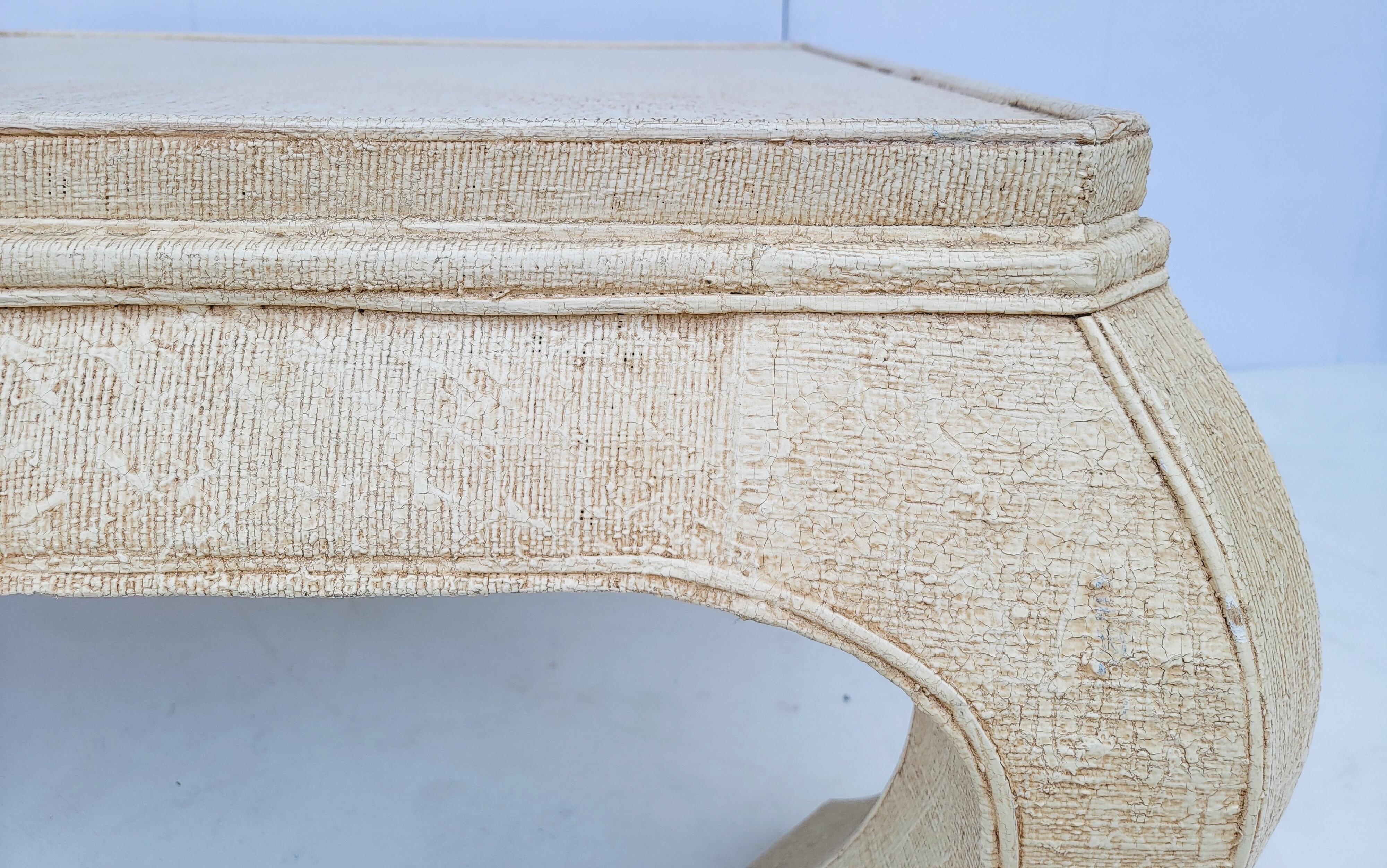 This is a 1970s Asian modern style grasscloth wrapped coffee table . The grasscloth is in good condition, and the piece good also be lacquered. It is unmarked. There is a glass top for protection.