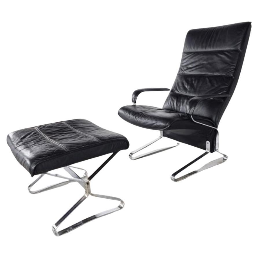 Here is a rare and comfortable 1970s German thick black cushioned leather and unique chromed steel frame lounge armed chair and ottoman. This is a statement piece within it's own. Perfect as a side armed chair and even piece of art to go in any