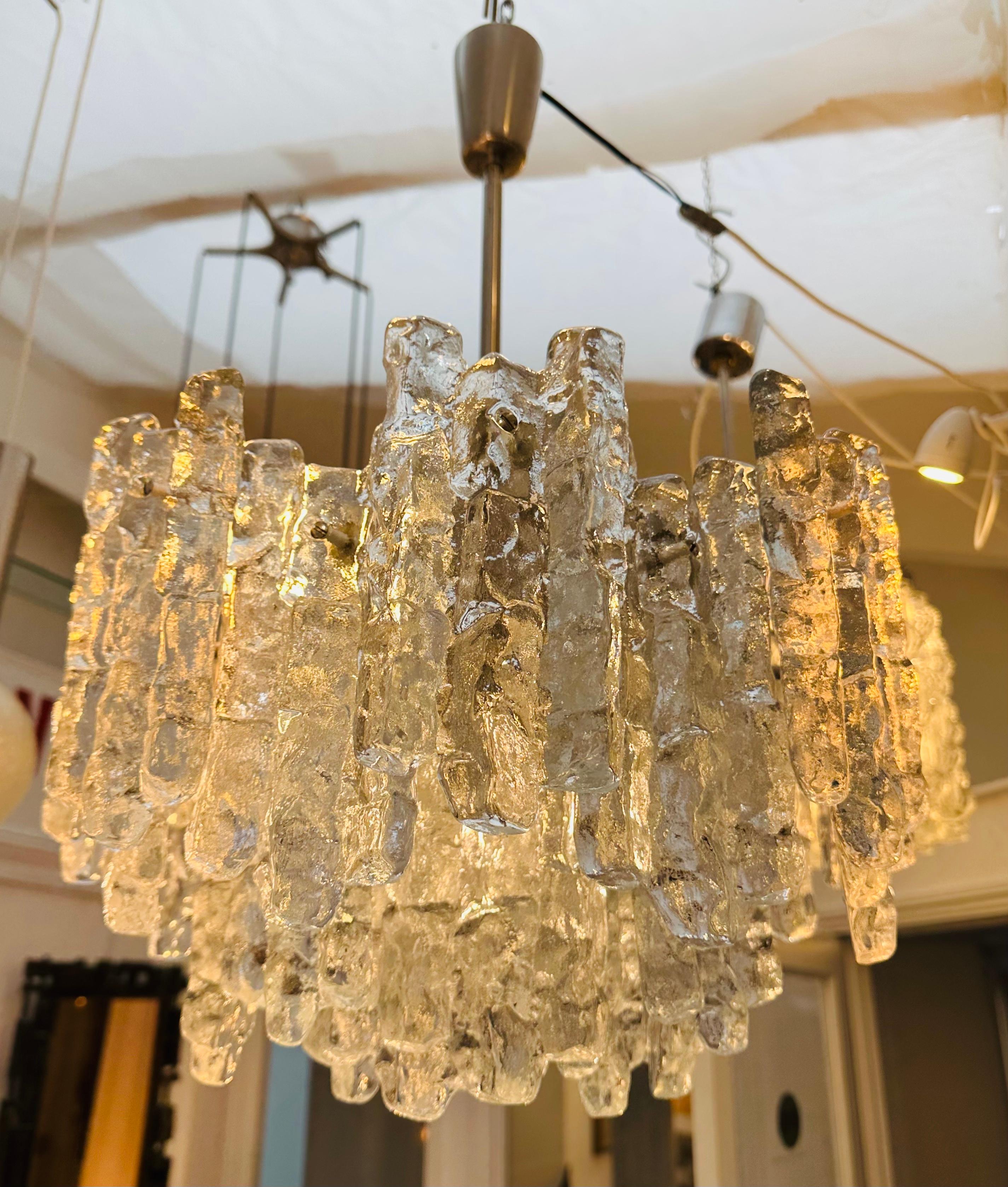 A striking and rather dramatic, two-tier, iced glass, chandelier which was manufactured by Kalmar Lighting in Austria in the 1970s from the SORIA range of lights. Designed by J.T Kalmar. Each piece of removable glass is secured onto the