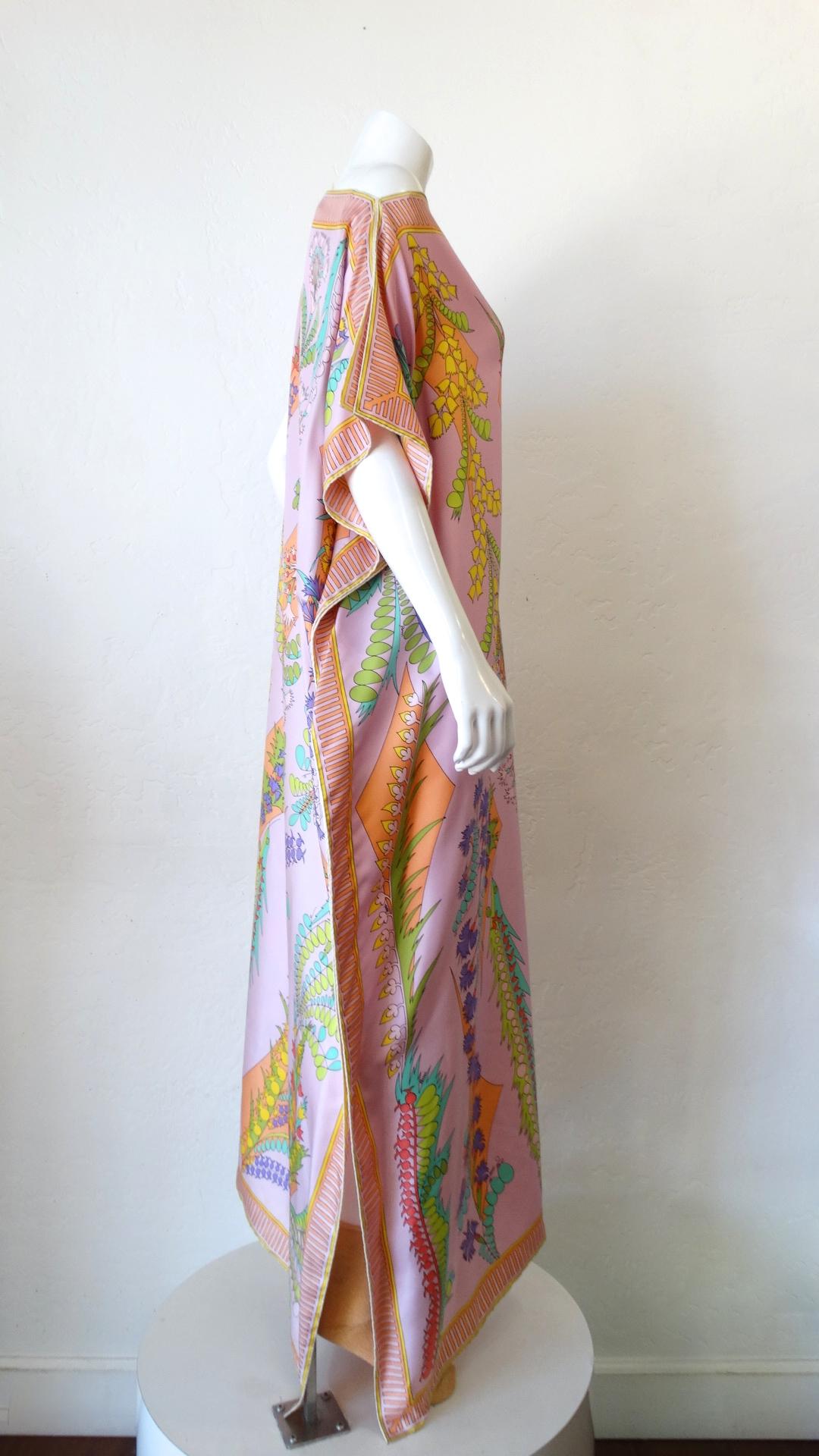 Always Be Ready For Vacation With This Amazing Kaftan! Circa 1970s, this Averardo Bessi kaftan features a vibrant floral motif, a decorative striped boarder and a high boat neck. Includes hook closures at the shoulders to create a small neckline.