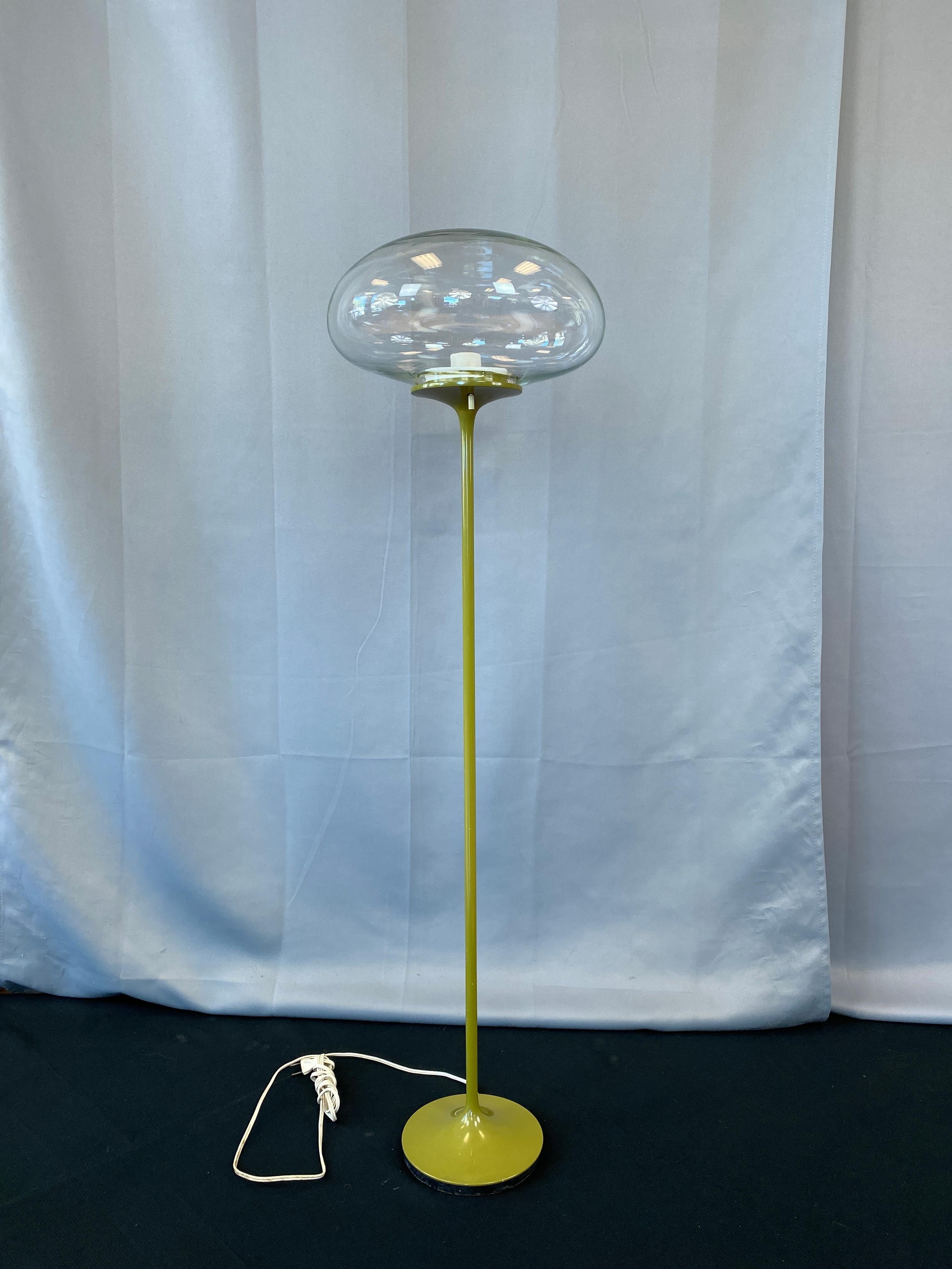 Floor lamp in Classic Avocado green, a Stemlite floor lamp by Bill Curry for Design Line, circa 1970s.
Round weighted base holds the long and slender stem, which in turns holds the clear glass orb shade.

Lamp is 43 1/2 inches tall, shade 12 1/2