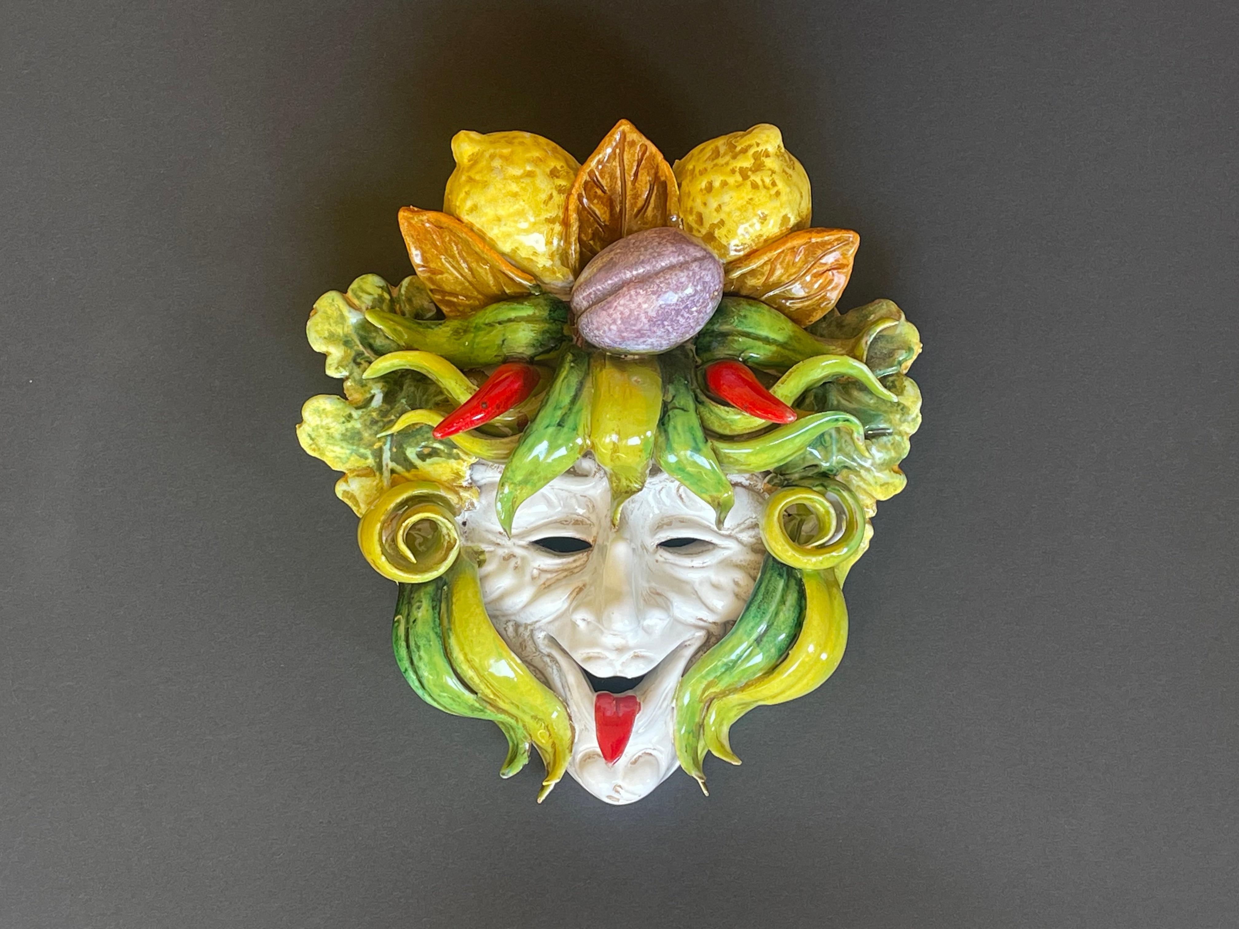 Absolutely impressive Bacchus in the shape of a jester carrying a full bounty of the harvest on his head:
there is fiery red pepperoni placed as horns, a juicy plum, lemons and plenty of lettuce and green vines.
Splendidly crafted Majolika ceramic