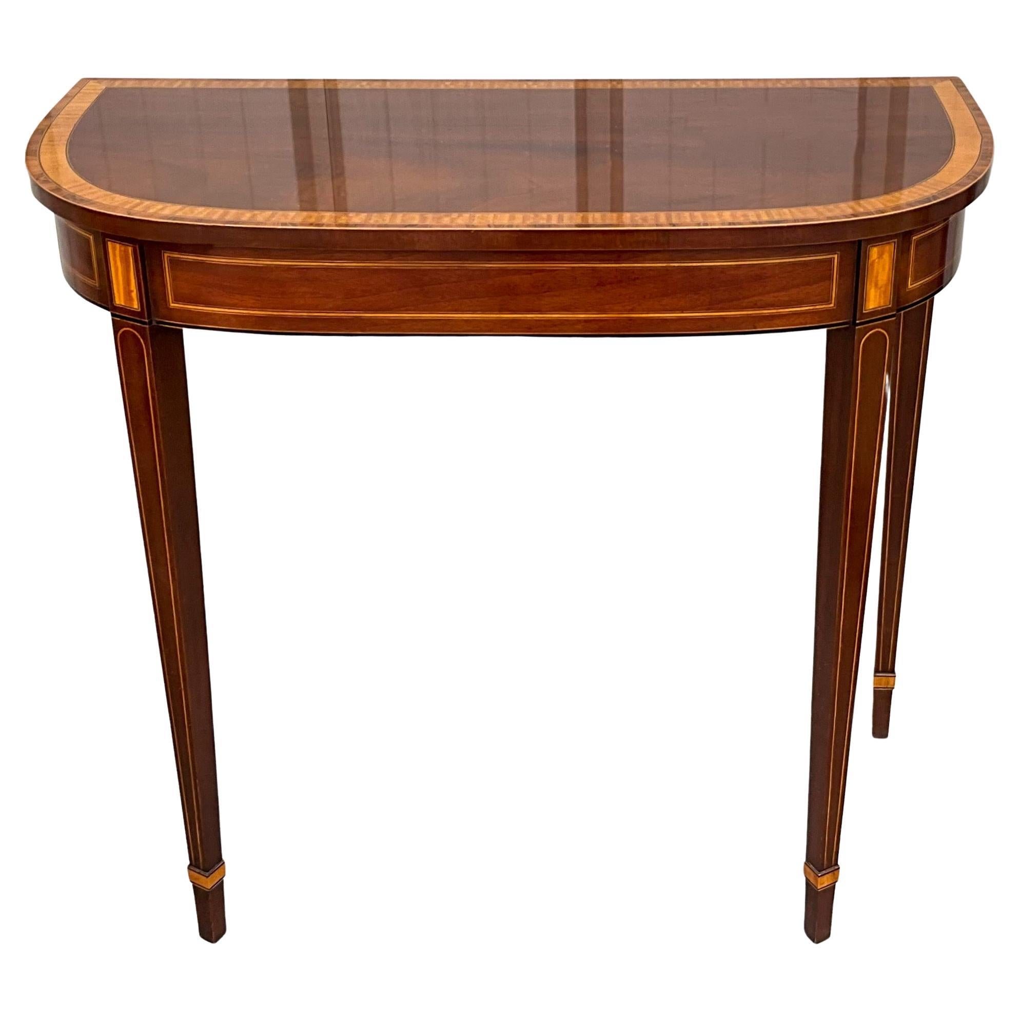 This is a classic piece with timeless appeal. The is a mahogany console table with Federal styling. It is by Baker Furniture Company. It is purported to be part of the Historic Charleston Collection, but it is not marked as such.