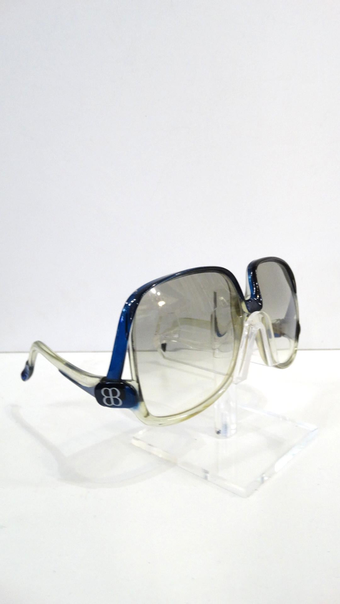 The Perfect Vintage Sunglasses For You! Circa 1970s, these Balenciaga oversized sunglasses feature clear grey tinted ombre lenses and a blue and clear grey frame. Includes low arms and the Balenciaga mirrored 