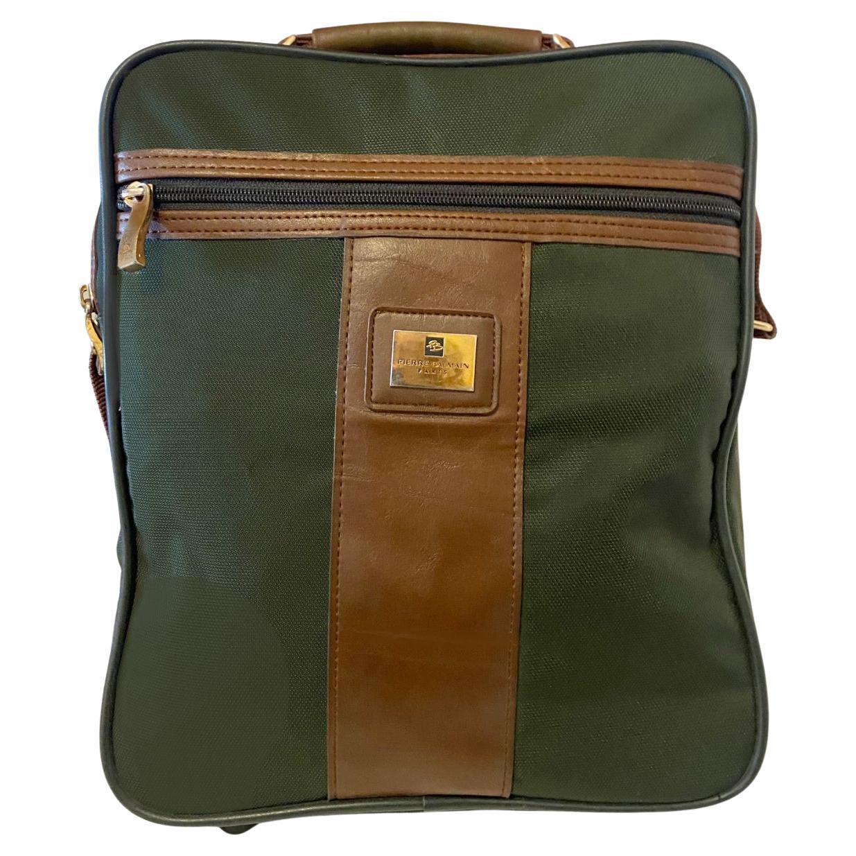 Vintage 1970s Pierre Balmain Cabin Travel shoulder bag in ark green canvas/polyester material with brown leather trim. Brass fittings (zip pulls, buckles,  multiple zipped compartments,  rubber feet at base, Made in France 

Condition: 1970s, very