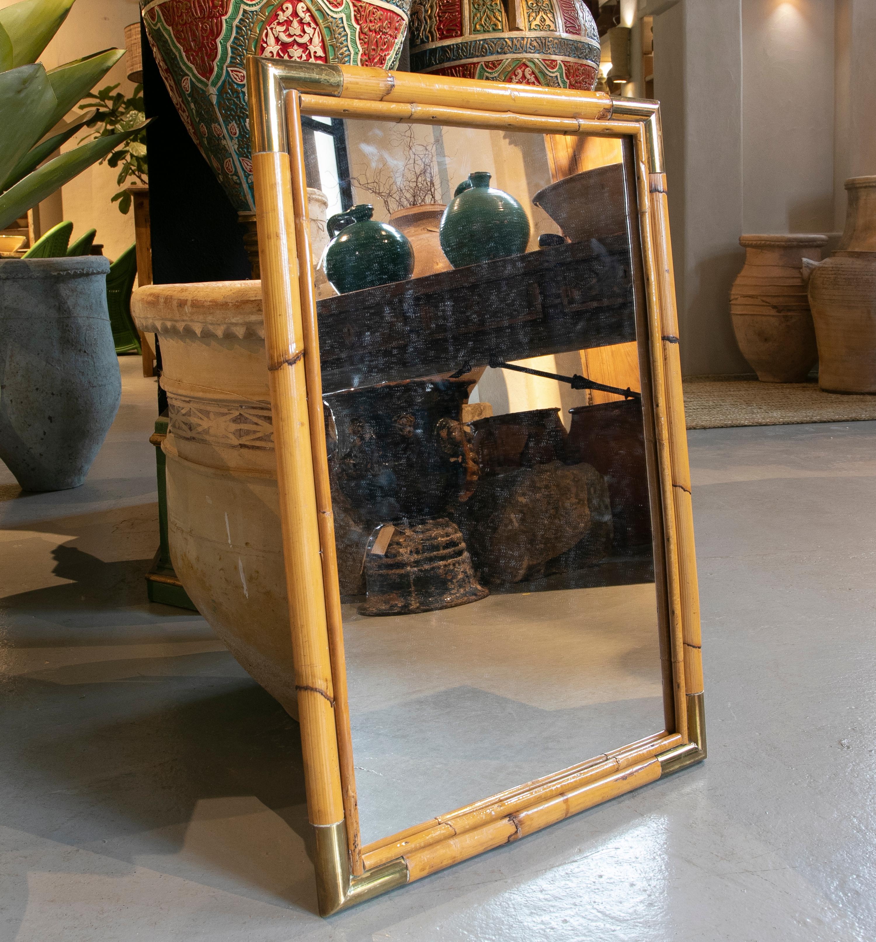 1970s bamboo mirror with bronze corners.