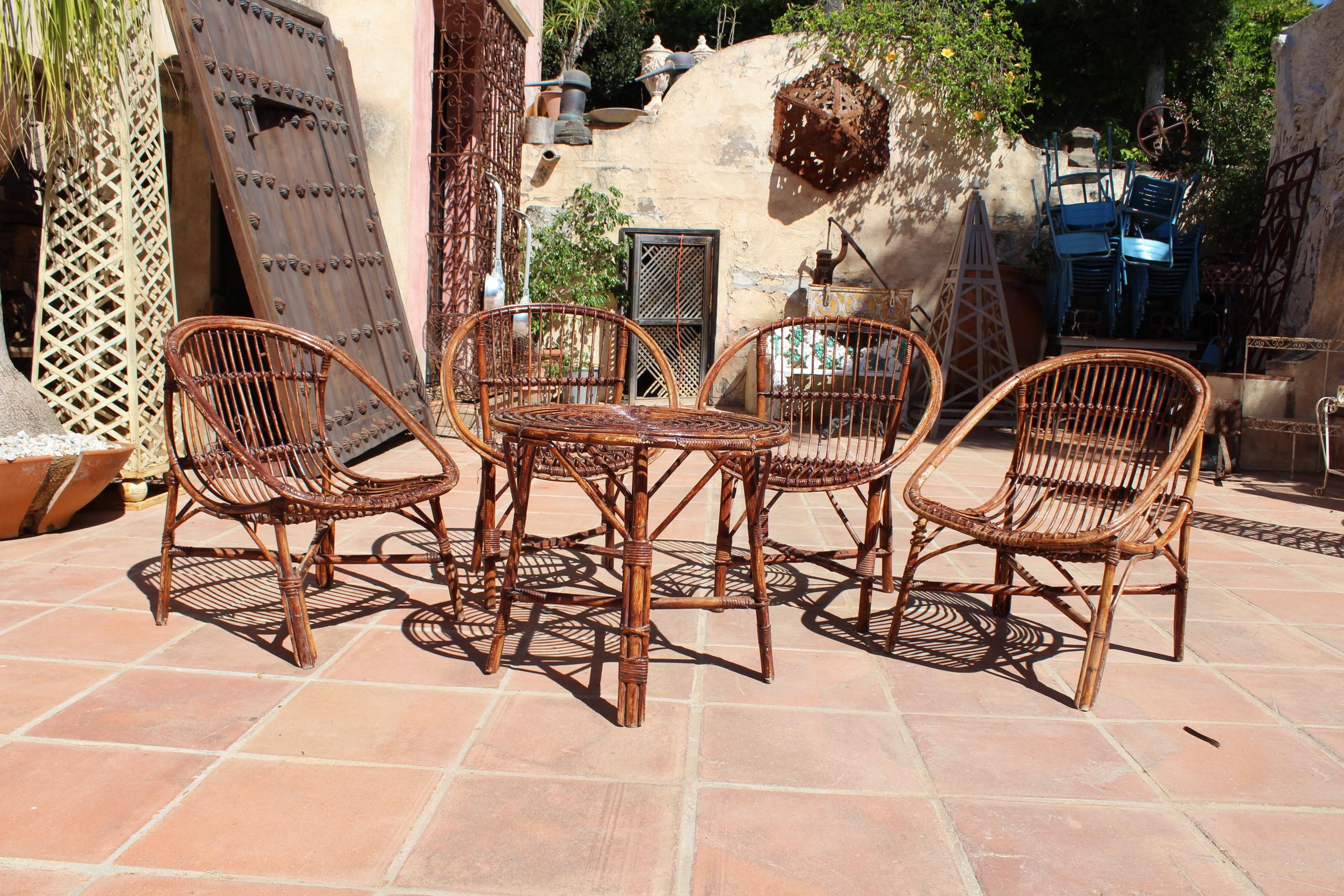 1970s bamboo set of four chairs and table. 

Measures: Table: 56 x 63 cm
Chairs: 76 x 59 x 70 cm
Armchairs: 80 x 66 x 50 cm.