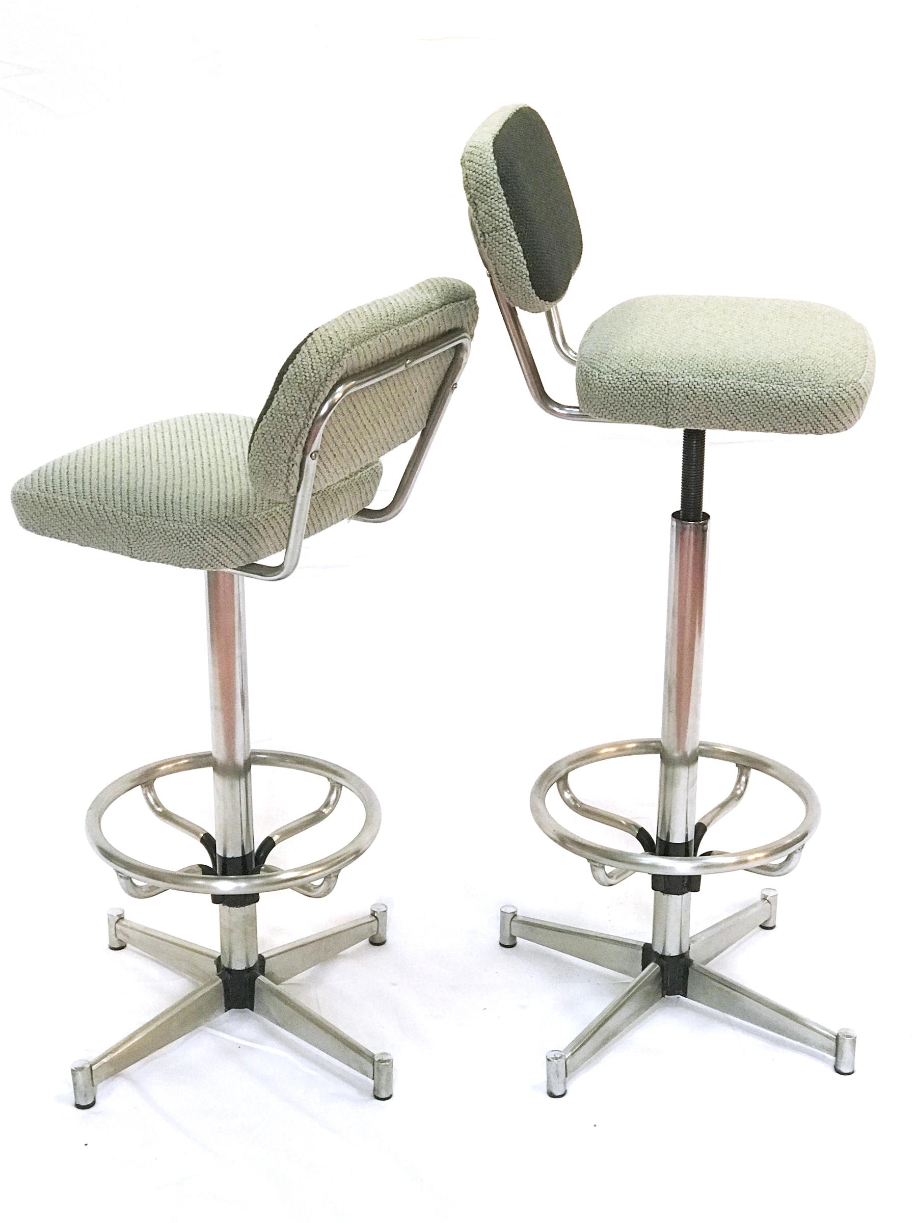 These bar stools are rotatory and are seating height adjustable from 70 cm to 91 cm. The seat dimensions are 36 x 32 cm. Base is bigger for good stability. They have been polished and reupholstered with kvadrat wool.