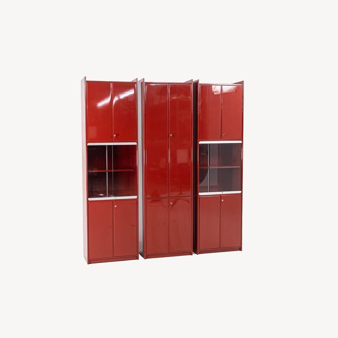 This is a tall, lacquered wood Olinto cabinet with glass doors, designed in the 1970s by Japanese architect Kazuhide Takahama for B&B Italia. Takahama‚Äôs collection featured a series of modular cabinets that could adapt to the user‚Äôs changing