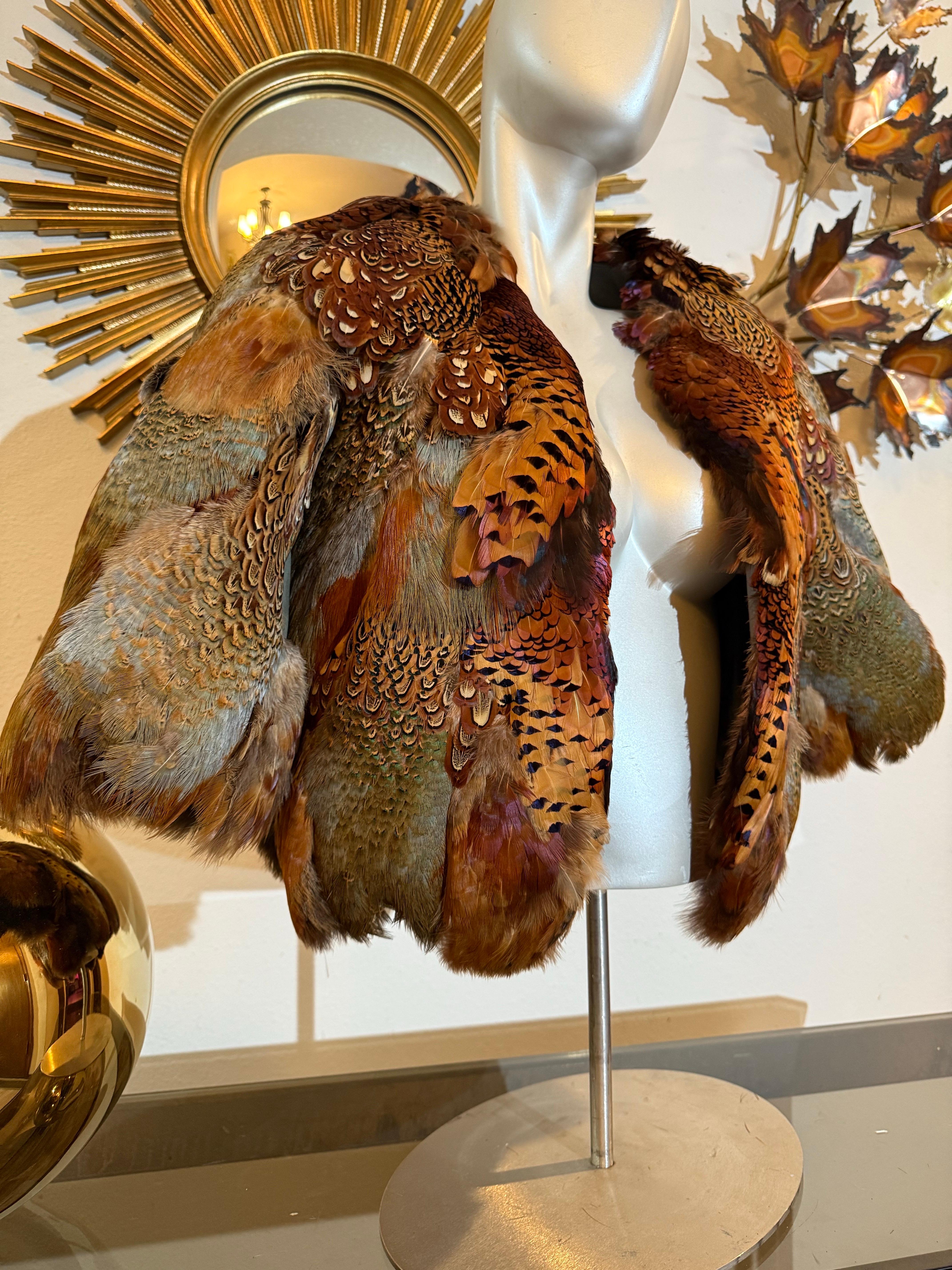1970s Becky Bisoulis Pheasant Feather Extravagant Patchwork Bolero Jacket:  This extremely rare couture quality piece, custom made by Becky Bisoulis is densely  feathered and constructed in a symmetrical,  patchwork style. Over-the-top Art-To-Wear.