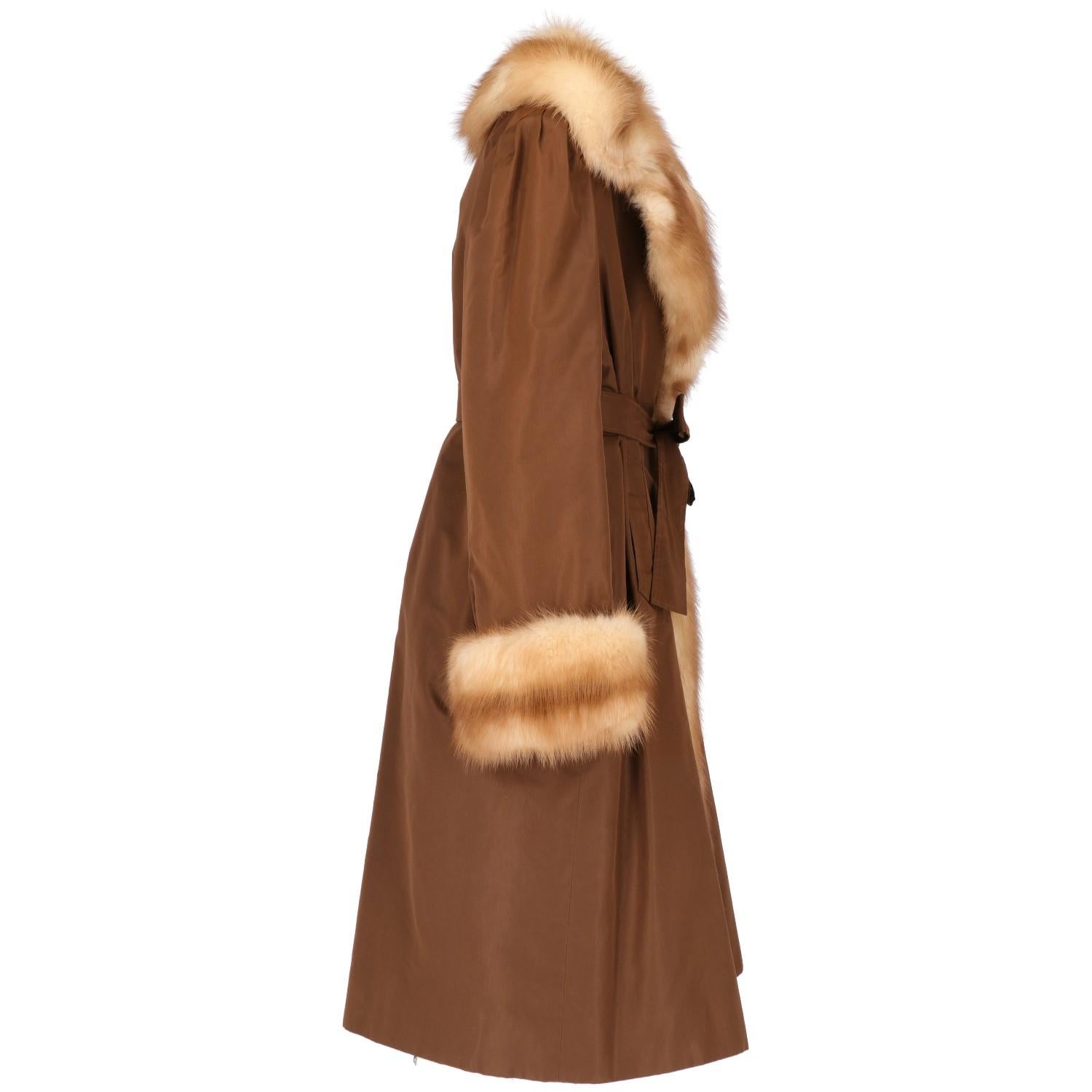 The regal brown coat with beech marten fur  at lining, edges, cuffs and collar, features  two welt front pockets, one inner pocket and one belt at waist. 
Please note this item cannot be shipped outside the European Union. 
 Years: 70s

Size: 44