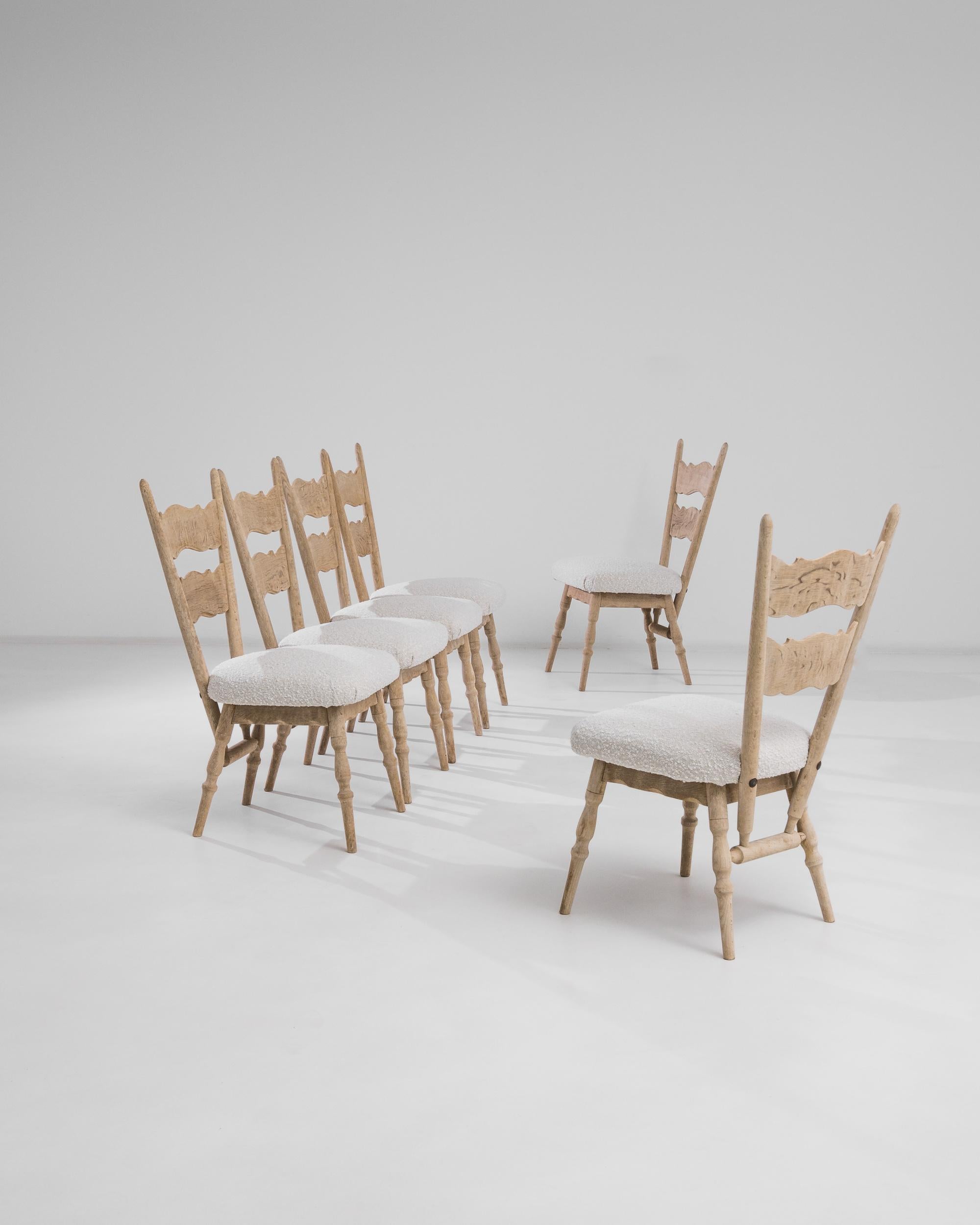 A set of six 1970s Belgian bleached oak dining chairs. Constructed from solid bleached oak, and updated with a creamy white boucle´ fabric, this set of chairs radiates both stylishness and welcoming. Finely lathed arms and legs, in addition to