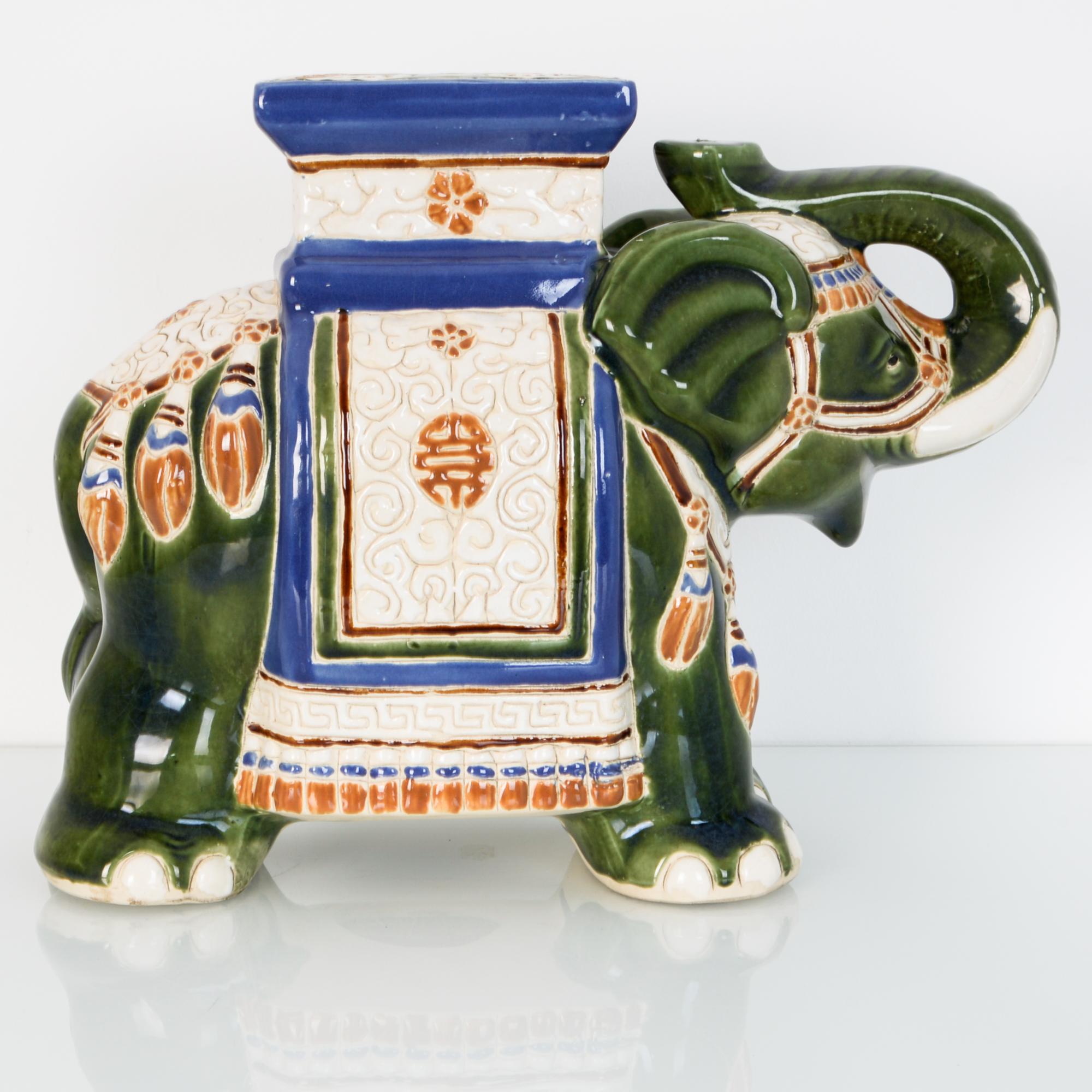 A decorative mid-20th century style, features oriental influenced elephant motif, cast in ceramic. This 17.5” chinoiserie garden stool is glazed in bright white, a versatile decoration or functional seat.