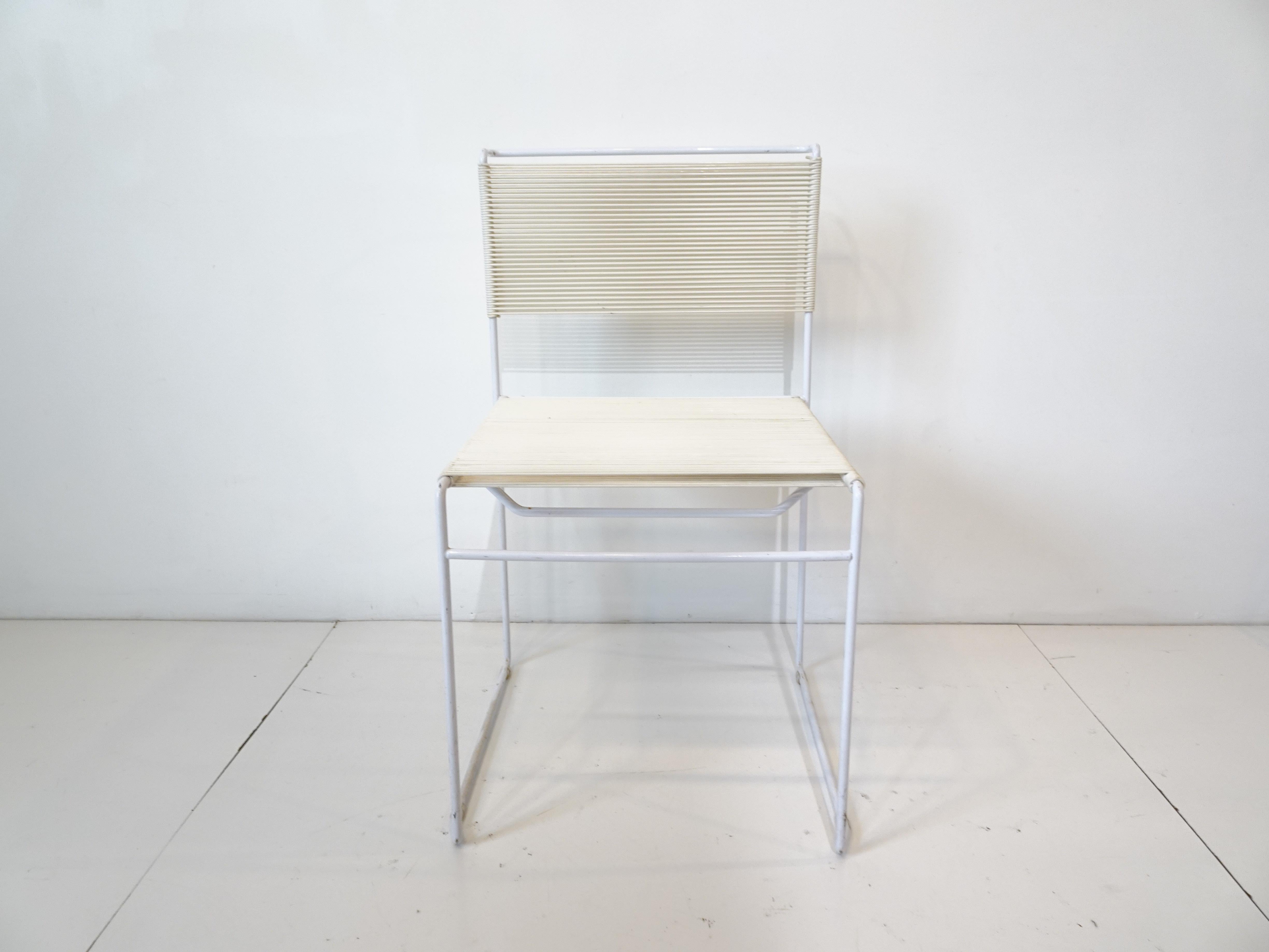 A set of four white PVC steel framed dining chairs with nylon rope woven seat and back called the Spaghetti chair designed by Giandomenico Belotti. Manufactured in Italy by Flyline / Alias having that Memphis styled look that is simple yet using