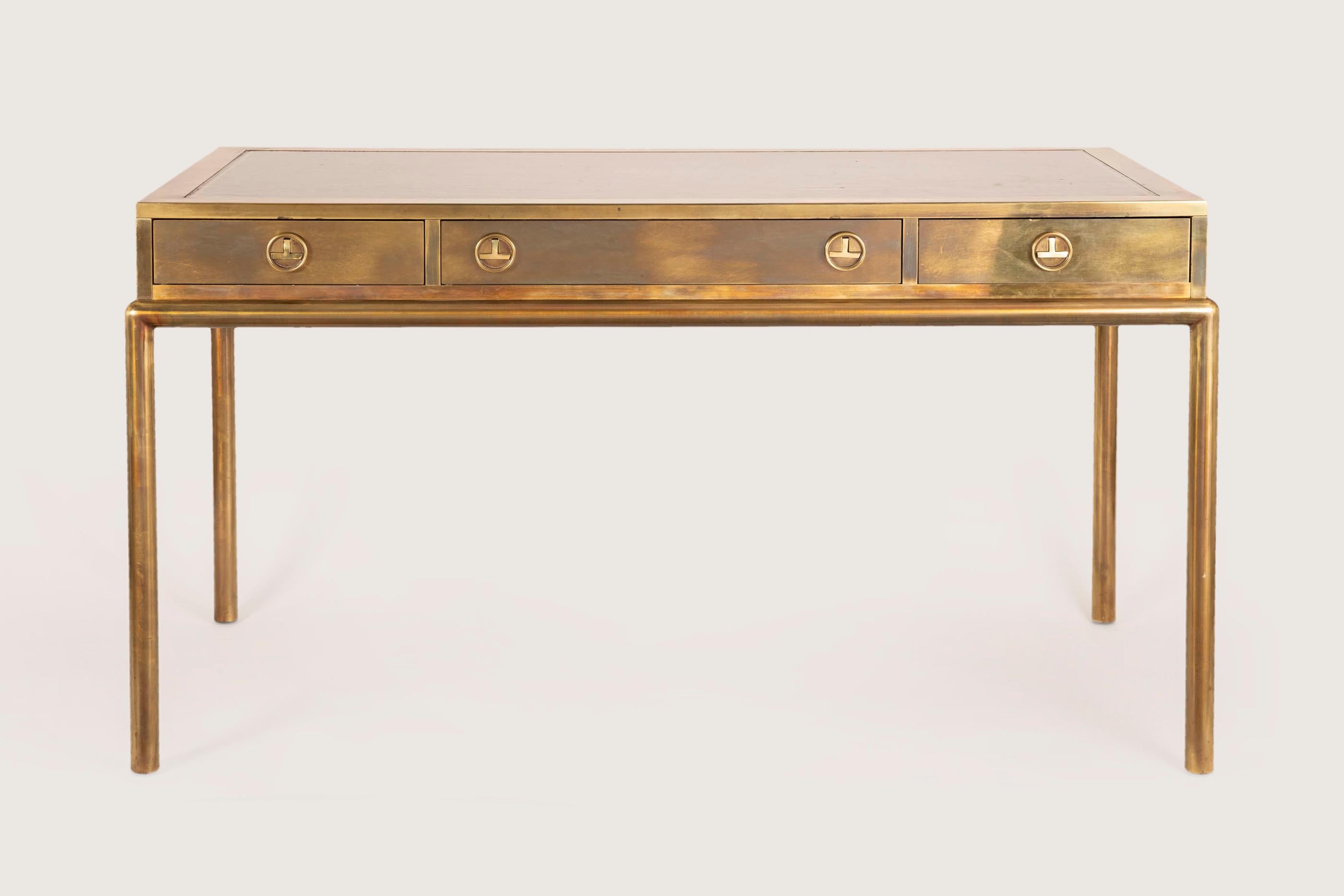 Stylish Bernard Rohne brass and bronze desk, Mastercraft, circa 1970. 

This fine three drawers desk is made of solid patinated bronze over wood construction, with brass and leather. The whole showing leather top with gilt tooled design border.