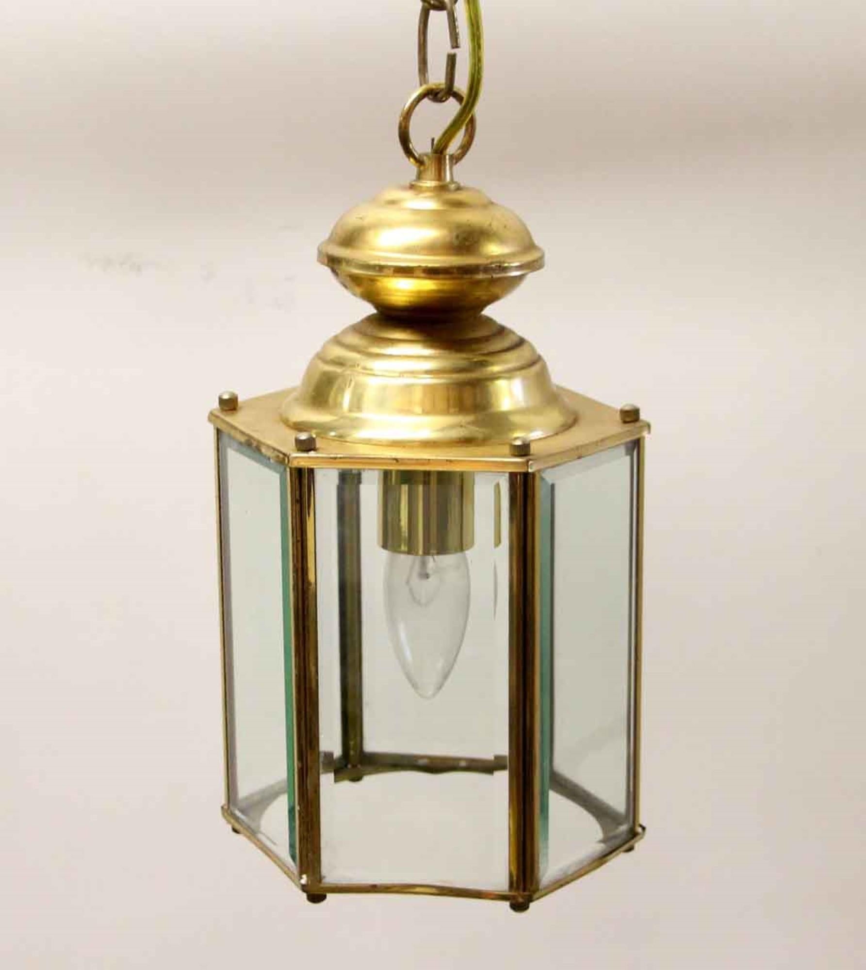 1970s hexagon shaped pendant lantern with beveled glass with brass hardware. This can be seen at our 400 Gilligan St location in Scranton. PA.