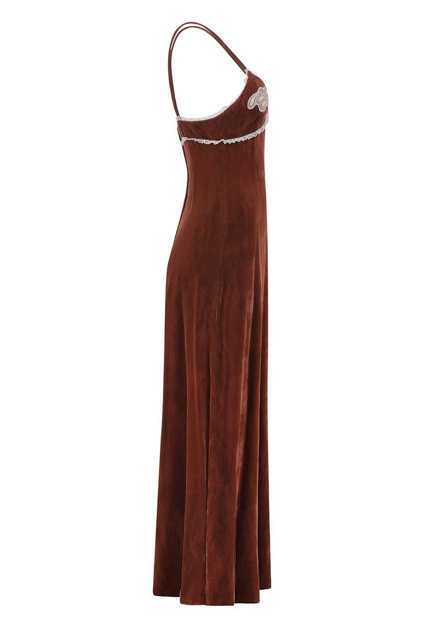 This seductive 1970s velvet maxi dress in rich chestnut brown is by popular British label Biba and is in lovely vintage condition. The dress is a slip style with thin shoulder straps and features front facing ivory lace details over the bust.