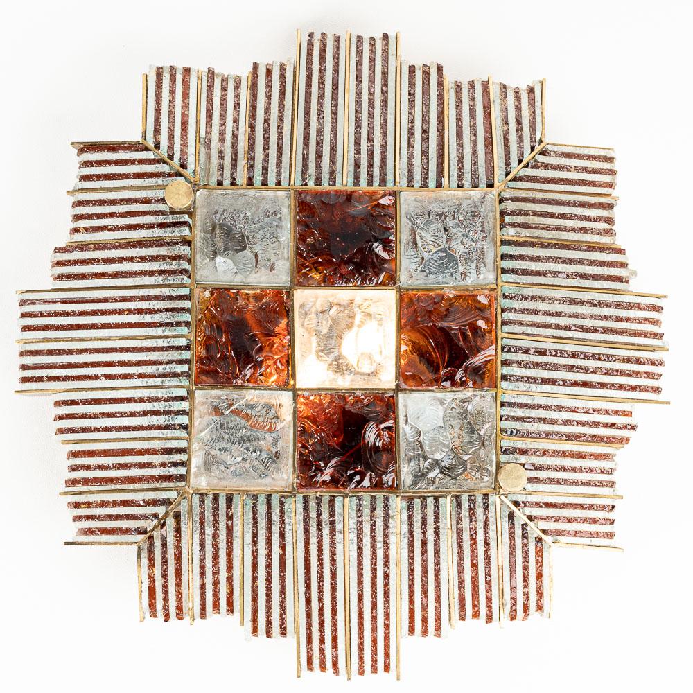 A beautiful 4,5 kilo sconce with thick bicolor Murano glass fronts. Clear and Amber handblown raw strips, chiseled squares and a steel back plate. It holds two E14 sockets. Two side strips have been freshly glued because they were a little loose.