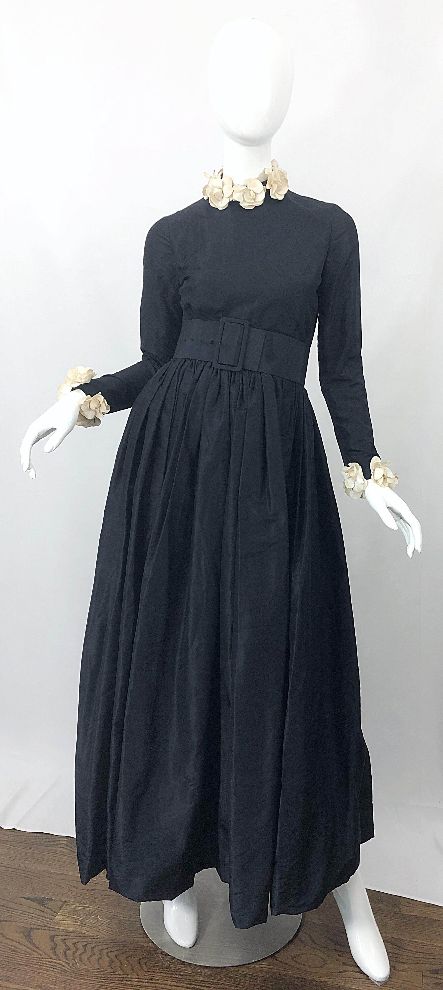 Sensational early 1970s BILL BLASS black and ivory camellia flower open back long sleeve silk taffeta 70s gown! Features a fitted high neck bodice with an open back. Neck and sleeves are adorned with removable ivory camellia flowers. Extra wide