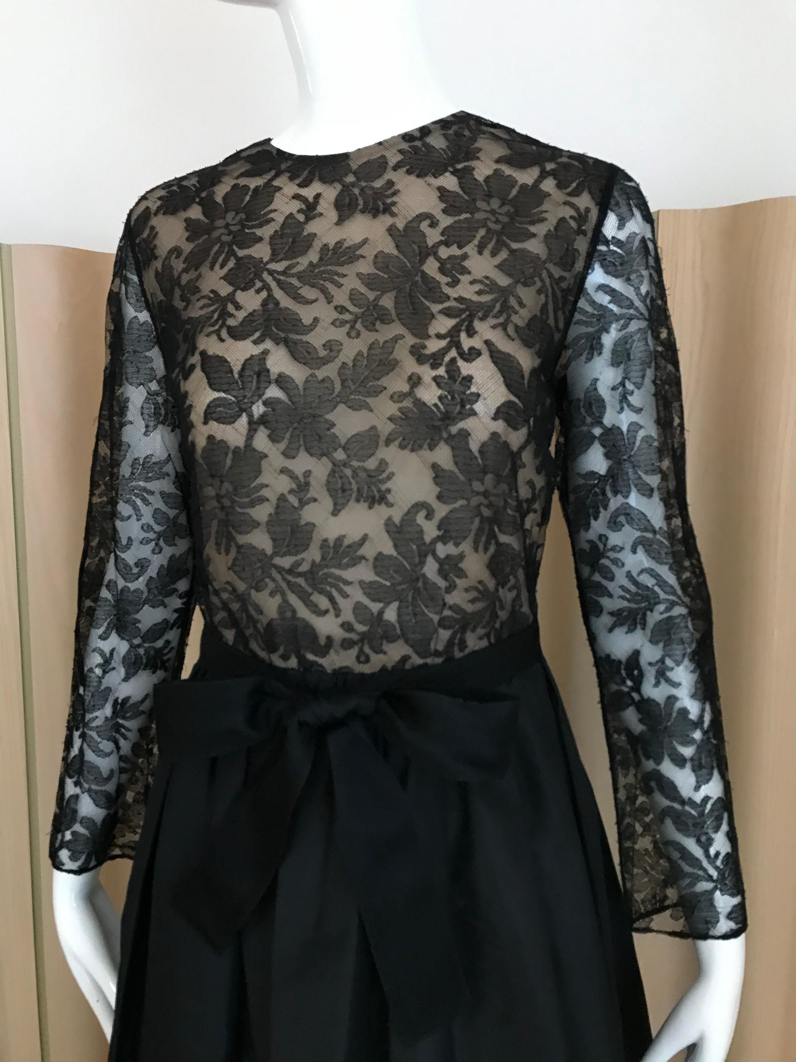 Vintage 1970s Bill Blass Black Lace long sleeve dress with silk taffeta skirt and black ribbon sash.
Perfect for black tie event.
Size: Medium
Bust: 36 inches/ waist: 28 inches/ Dress length: 55inchess / sleeve : 22 inches