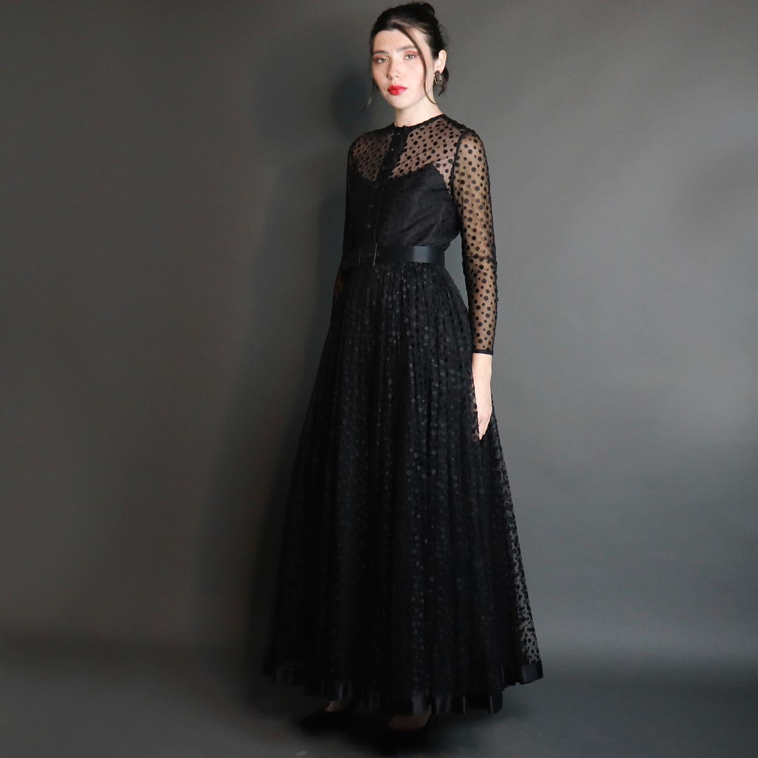 This is a truly sensational vintage black evening gown designed by Bill Blass in the 1970's. This gorgeous dress has luscious layers of black dot netting over black silk taffeta. The dress is fitted at the waist and has its original black silk belt