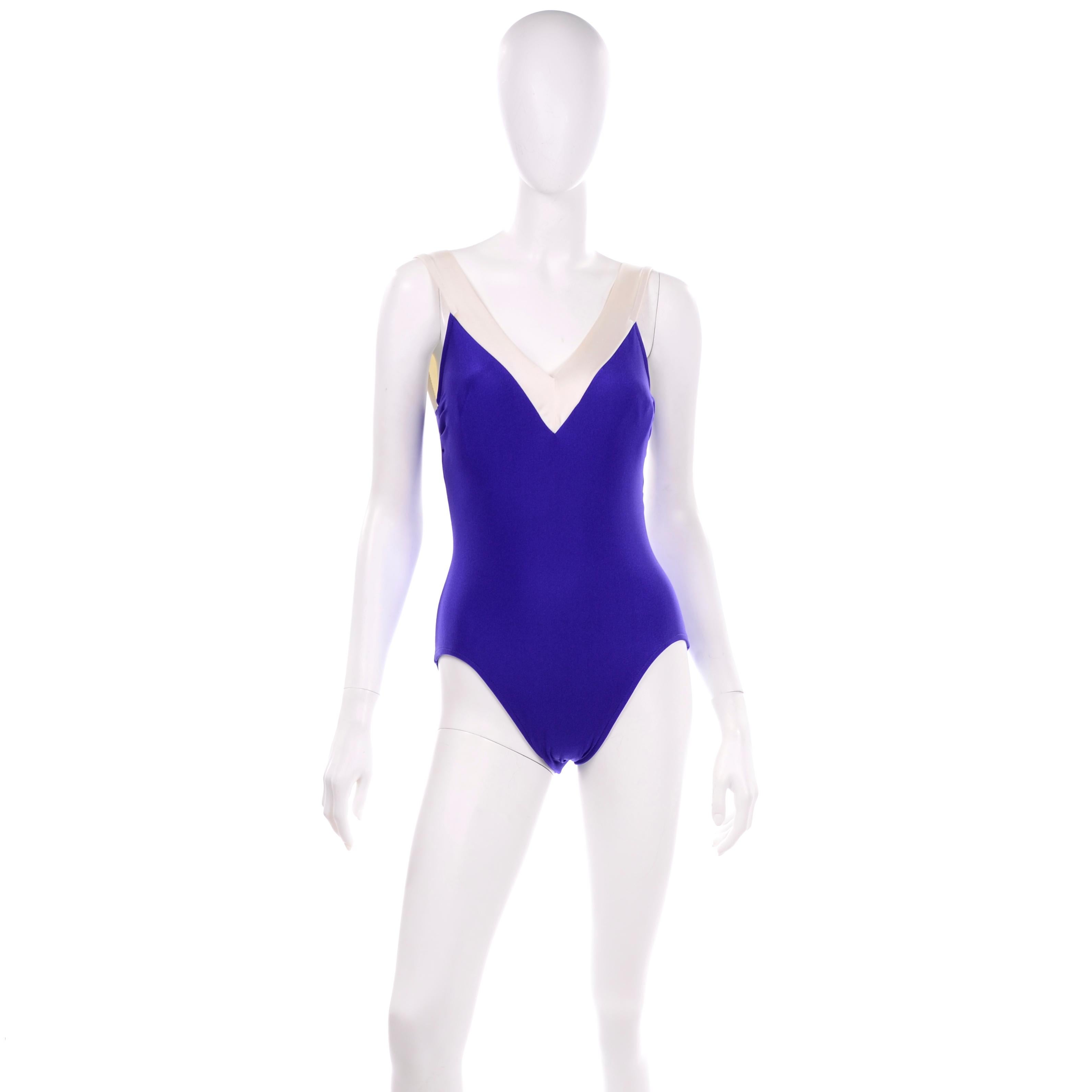 This vintage one piece purple/blue Bill Blass swimsuit is trimmed in ivory and has a low back.  High cut on the sides with soft cups, this suit was designed by Bill Blass and is very flattering! We estimate it to fit a size 10 but please use the