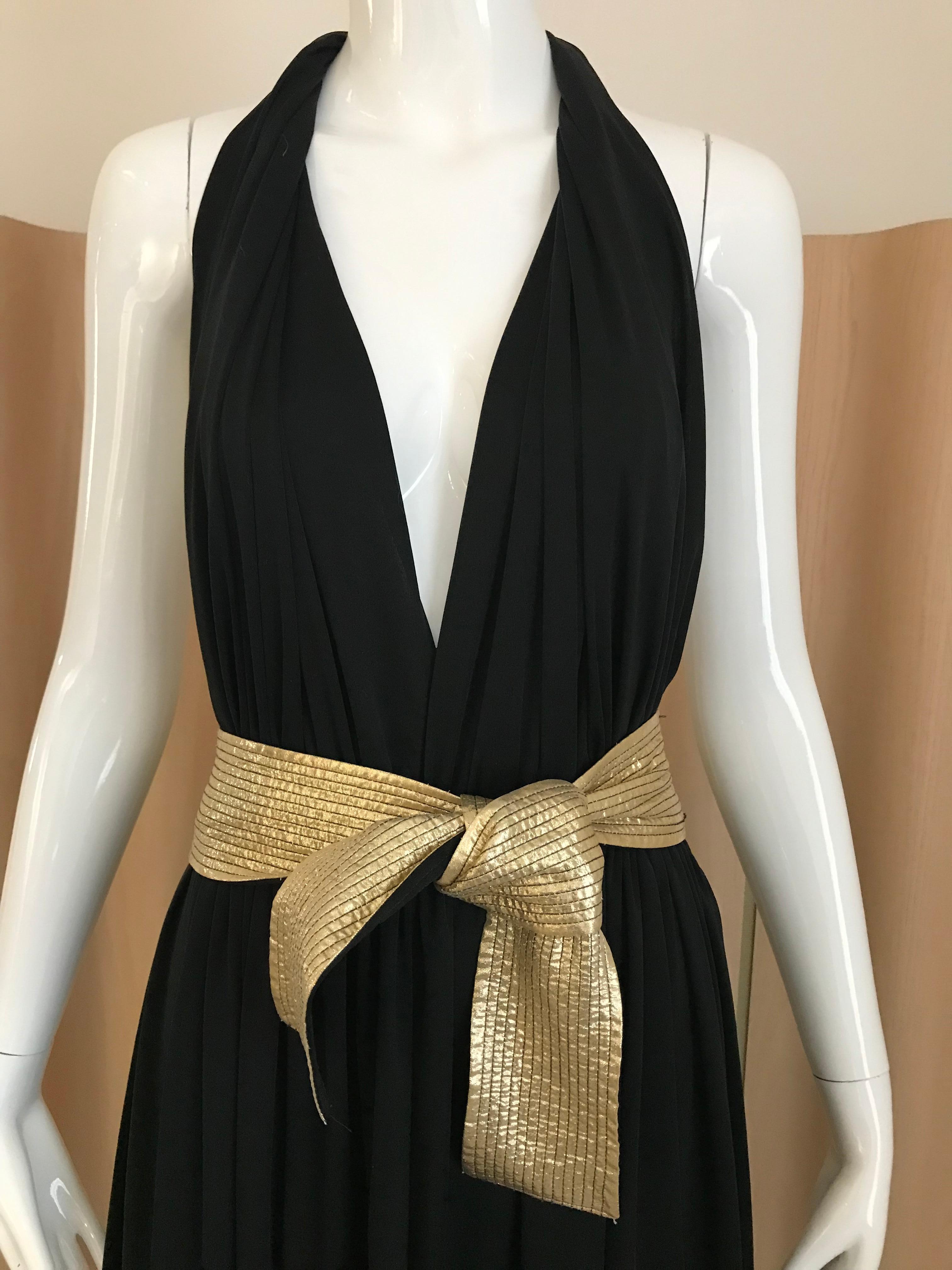 Vintage Black Bill Tice jersey halter dress with plunging neckline and bare back. Dress has gold attached belt/sash.  Perfect for studio 54 party theme .
Fit size small to medium
Bust: 38” / elastic waist : 34 inches/ length : 50 inches