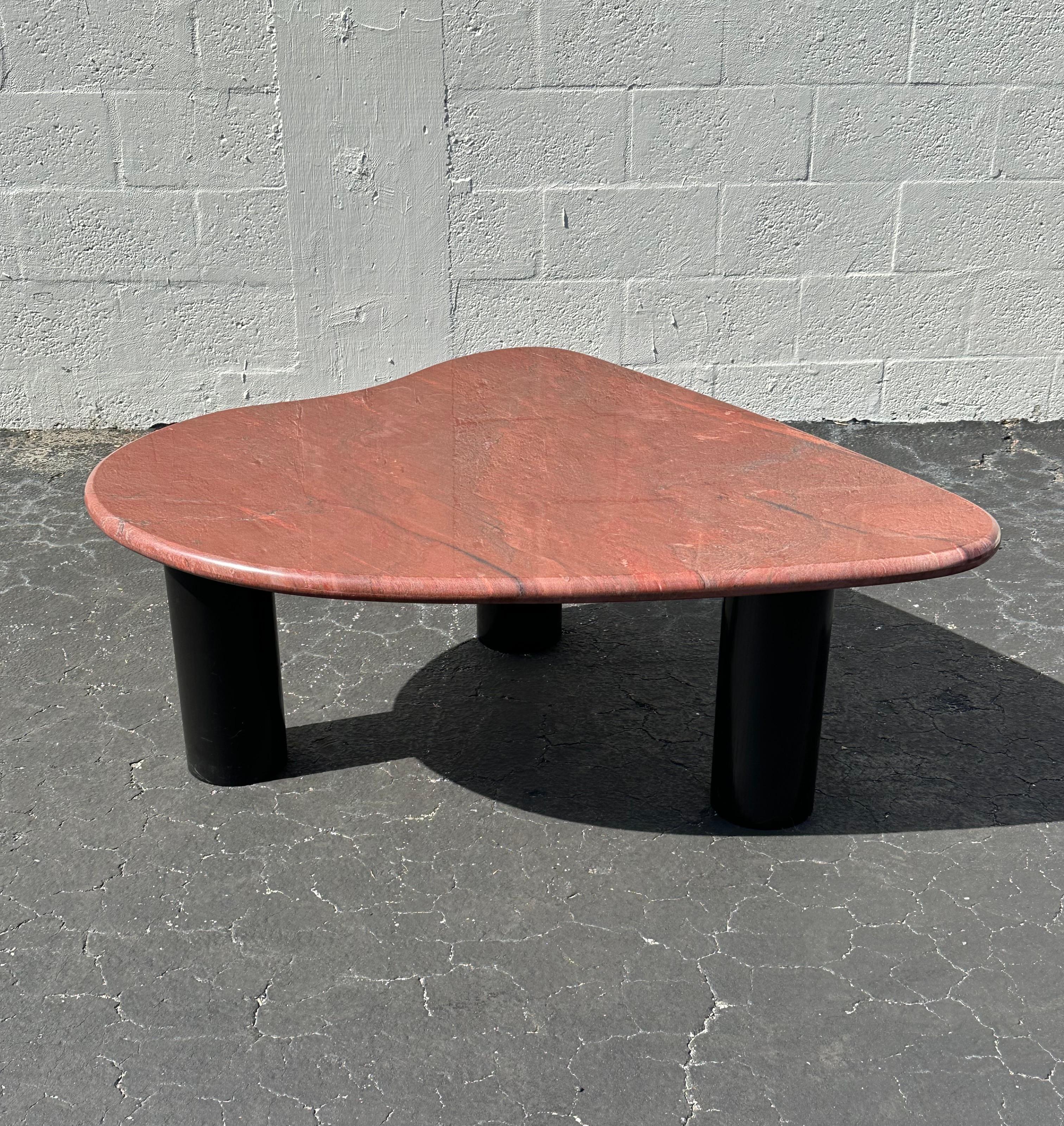 Indulge in the timeless elegance of this exquisite Freeform marble coffee table, dating back to the 1970s. Crafted with meticulous attention to detail, this piece showcases a stunning hand crafted finish, ensuring a rich, lustrous biomorphic