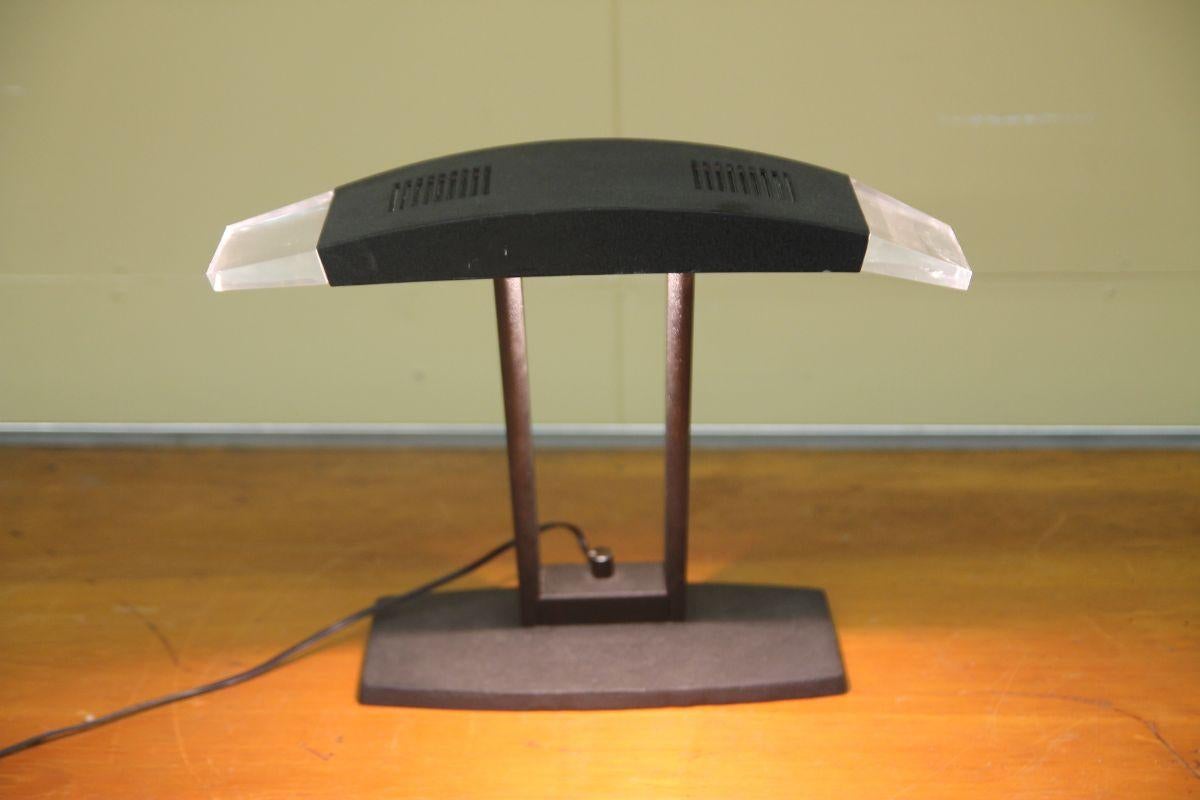 Great 1970's desk lamp. This is a well made lamp. I have been unable to find another example of this light but it does have a Italian feel to it. The lamp has a dimmer switch on base.