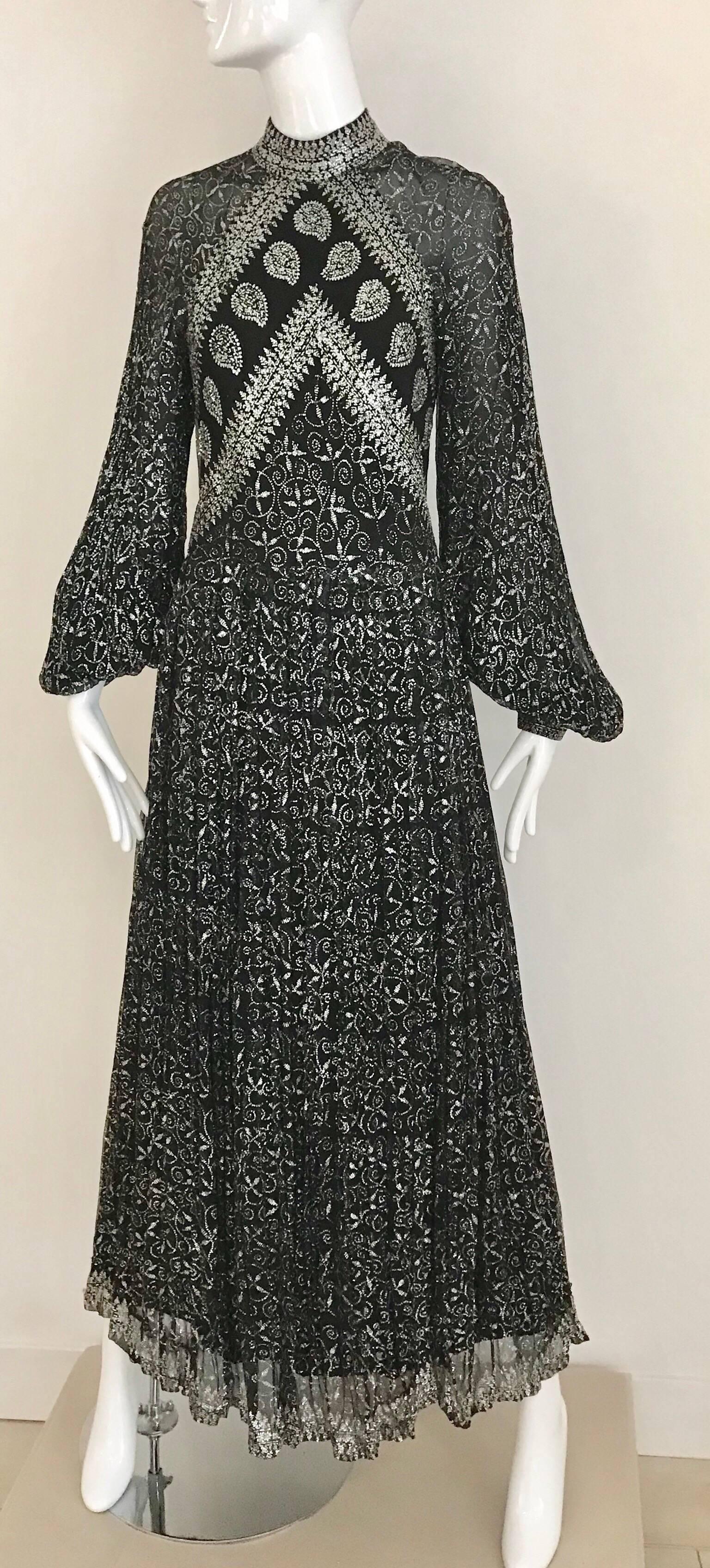 Vintage Black and silver long sleeve glitter maxi silk dress.
Dress zip at the back.  Fit size: 2/4 Small
Bust: 32 inch/ Waist: 25 inch / Hip: 38