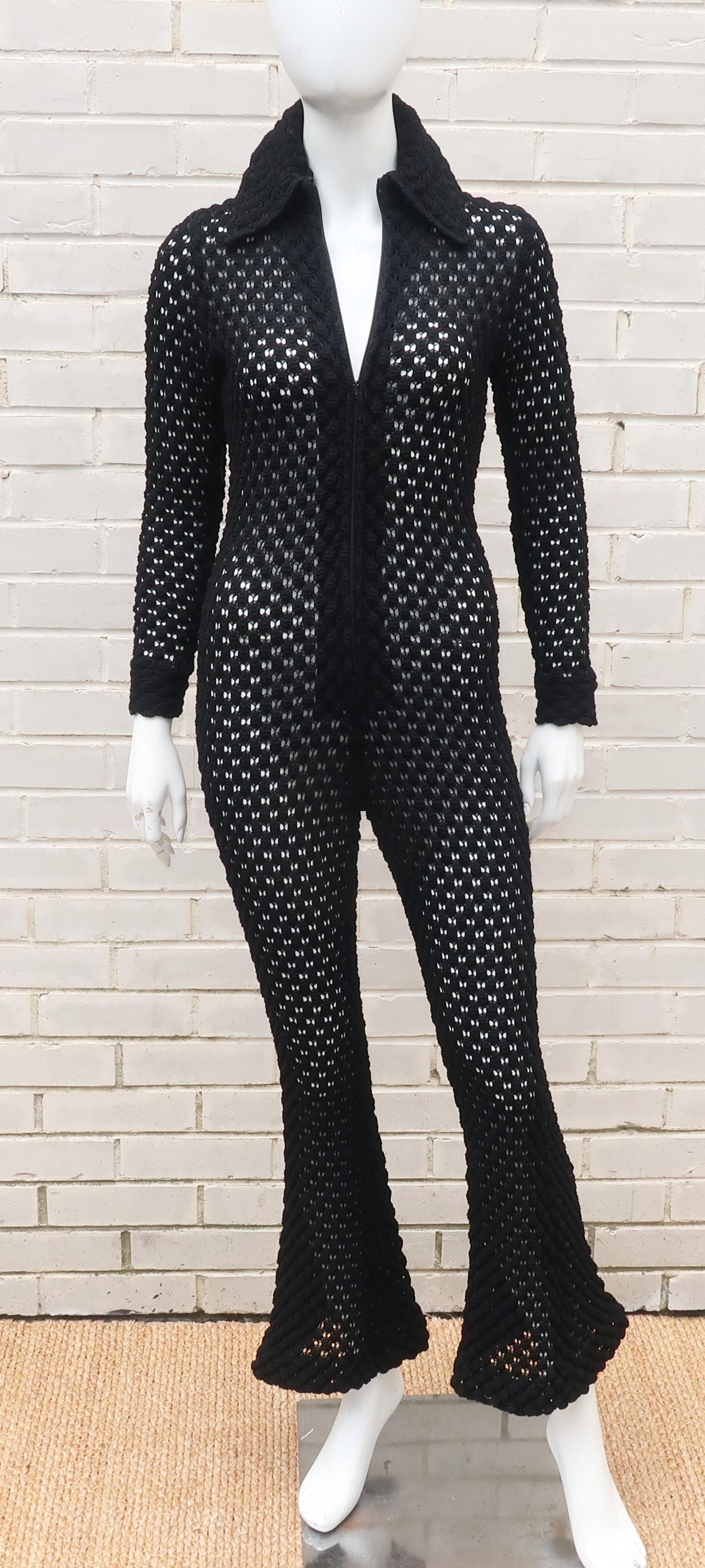 Boogie nights!  A period perfect 1970's popcorn crochet knit black jumpsuit with a zip up front, pointy collar and bell bottom pants hem.  Wear it with black undergarments or go for the nude illusion look.  Comfortable for lounging or disco dancing