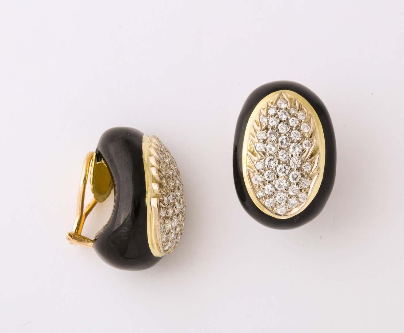 One Ladies Pair Of High Polish Black Enamel Earrings Embellished With Aproximatley 4 Carats Of Full Cut diamonds. Diamonds Beautifully Set In A 18kt Gold Flame Outline. Crated In The 1970's In The United States Of America.
