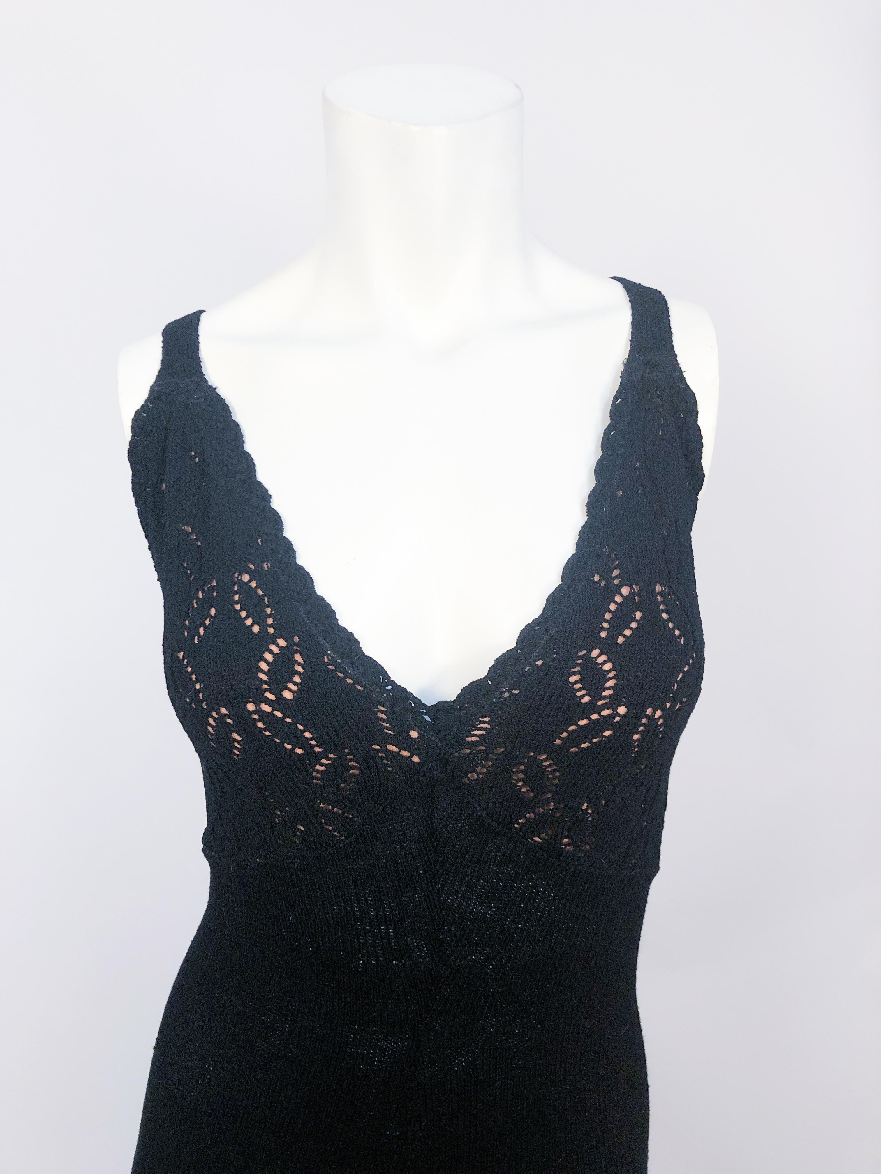 1970s Black Knit Jumpsuit with detailed pull work along the bodice and hem of the bell bottoms pants. The straps are cross-backed.