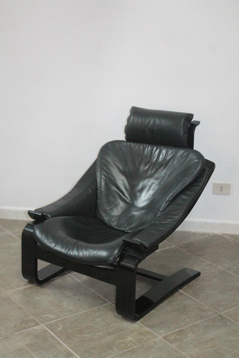 This Kroken chair in the very popular color combination blackblack comes in a good condition appropriate to age. The black leather and the nearly black wooden frame show slight signs of use. The edges of the headrest need some TLC. The Kroken Chair