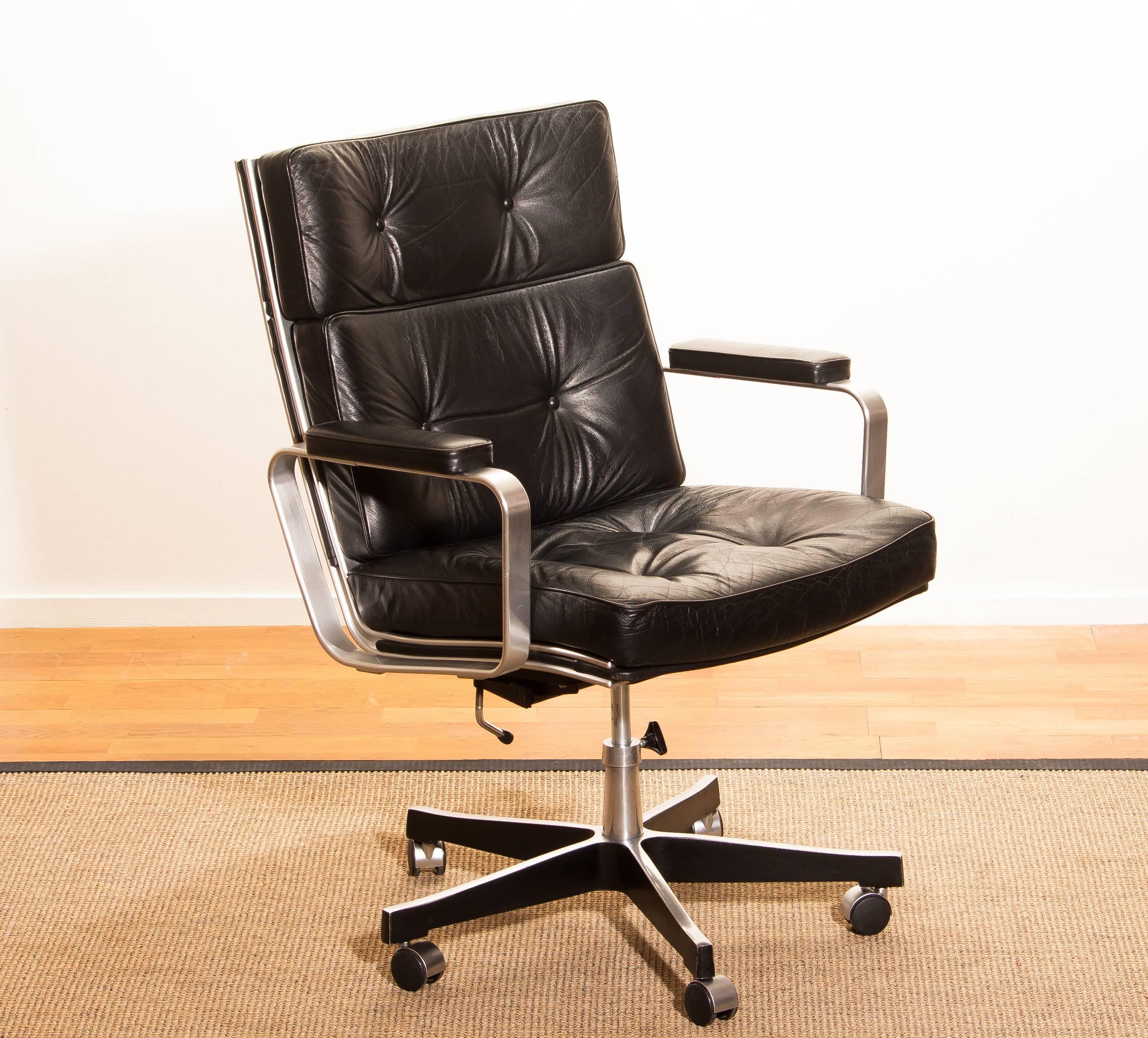 Beautiful adjustable office chair designed by Karl Erik Ekselius for JOC Möbler.
The nice thick solid black leather with an aluminium frame and steel five legs on wheels is a perfect combination.
The chair is extremely comfortable. 
With minimal