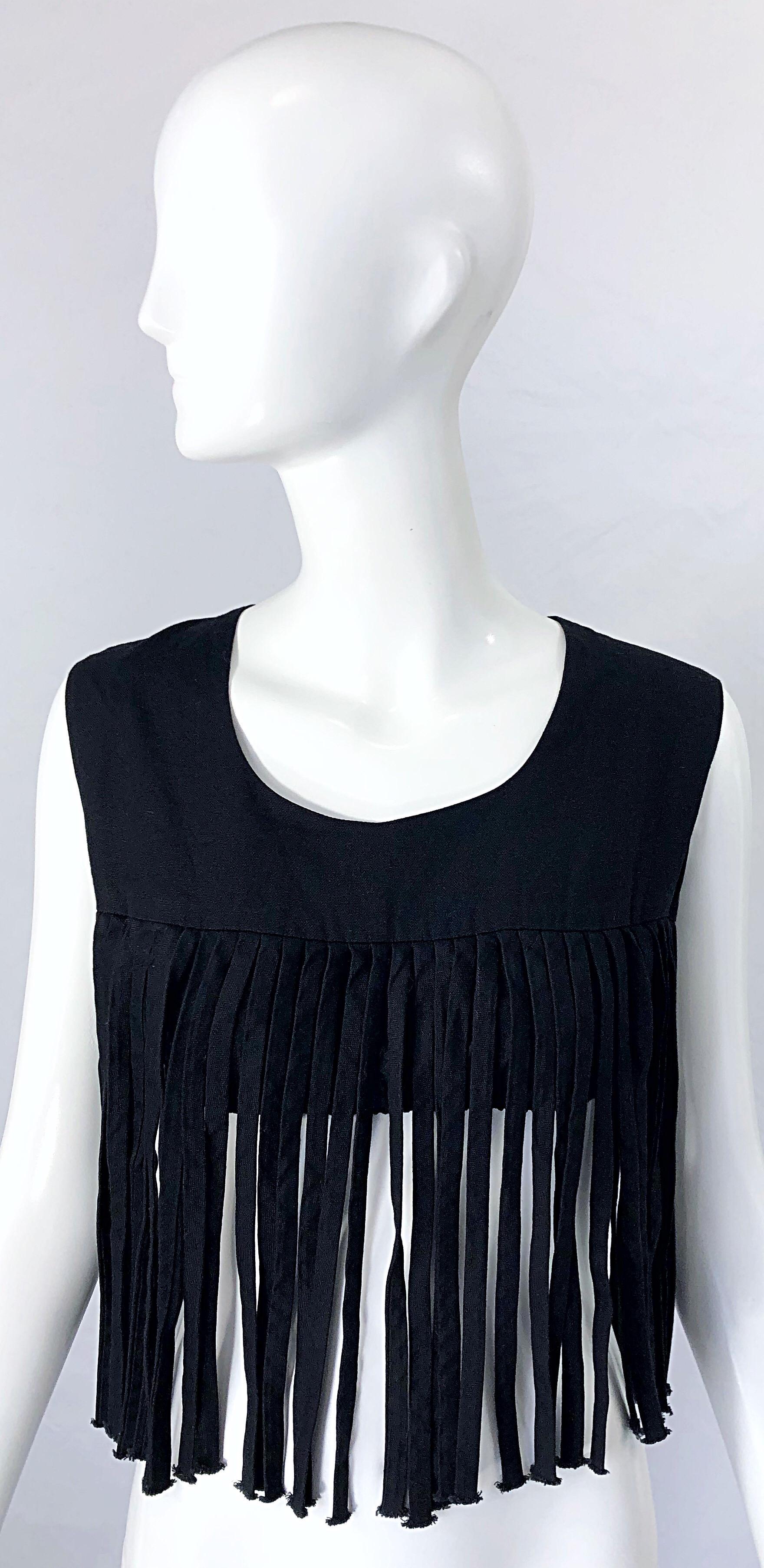 Boho chic black linen fringed crop top ! Features fringe around the hem on the front and back. Buttons up the back. Elastic band under bust keeps everything in place. Great with jeans, trousers, shorts or a skirt. 
Very well made in