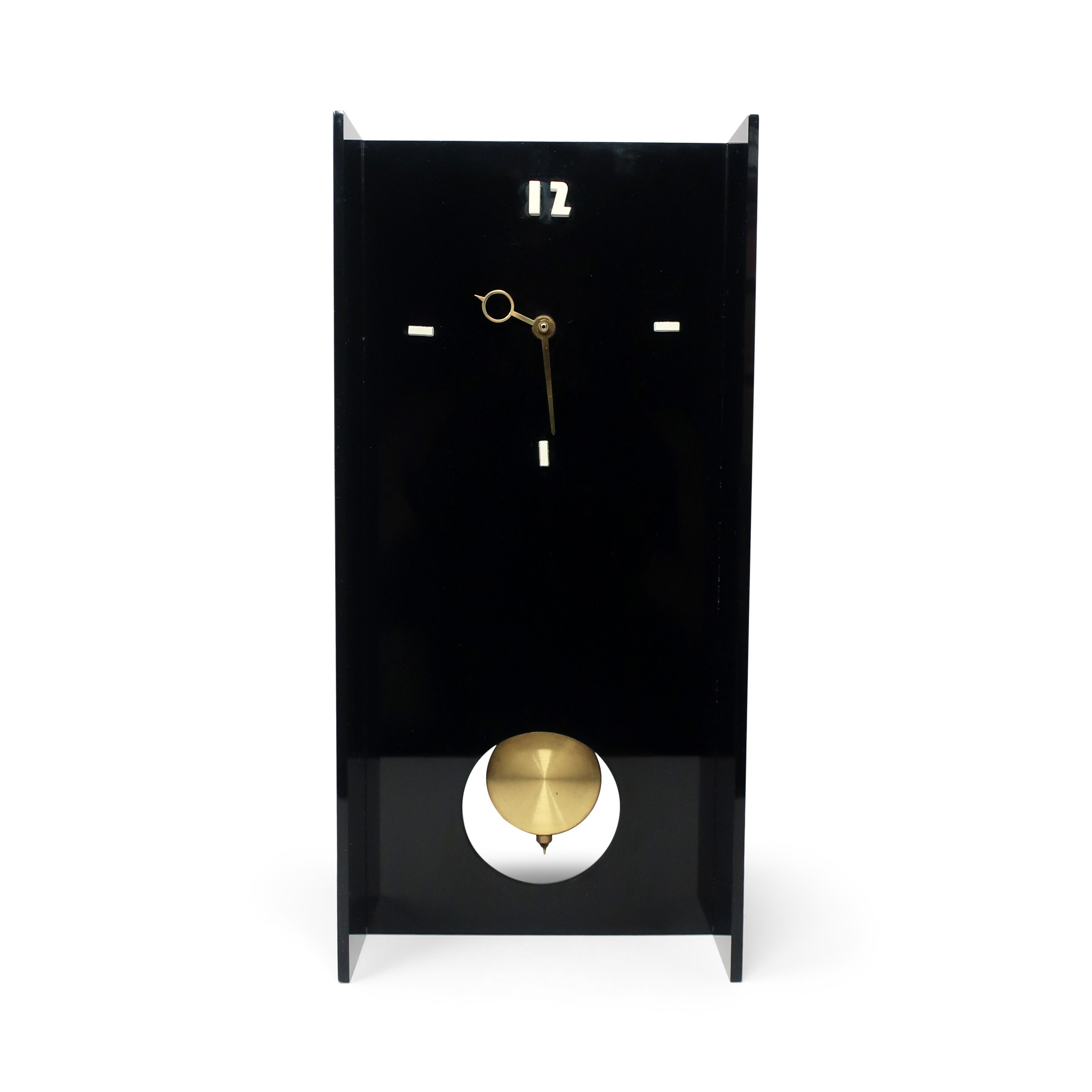 A fantastic black lucite wall or mantle clock from the 1970s with a black case, white number dashes and 