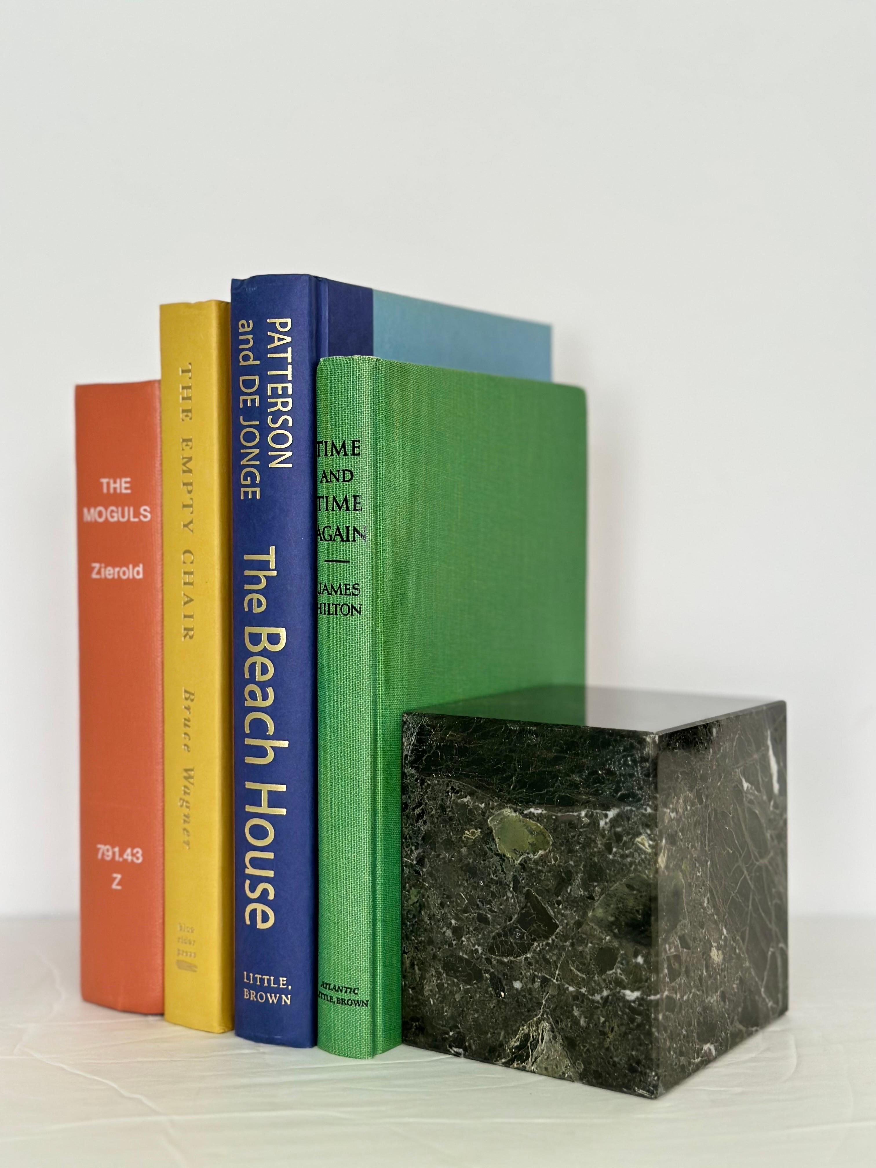 We are very pleased to offer a beautiful pair of bookends, circa the 1970s.  These sleek and modern bookends are crafted from black marble, exuding a sense of sophistication and simplicity.  Black marble is known for its smooth, glossy surface and