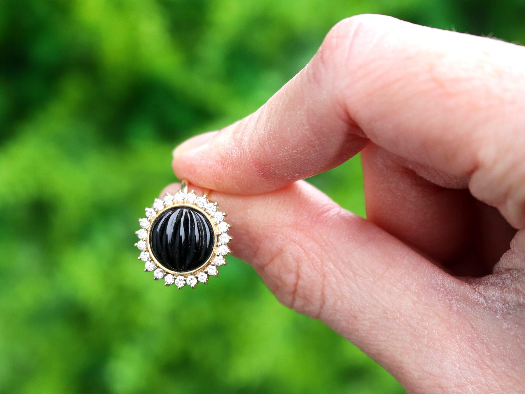 A fine pair of 0.45 carat diamond and black onyx, 14 karat yellow gold clip on earrings; part of our diverse vintage jewelry and estate jewelry collections.

These fine and impressive vintage diamond and onyx earrings have been crafted in 14k yellow