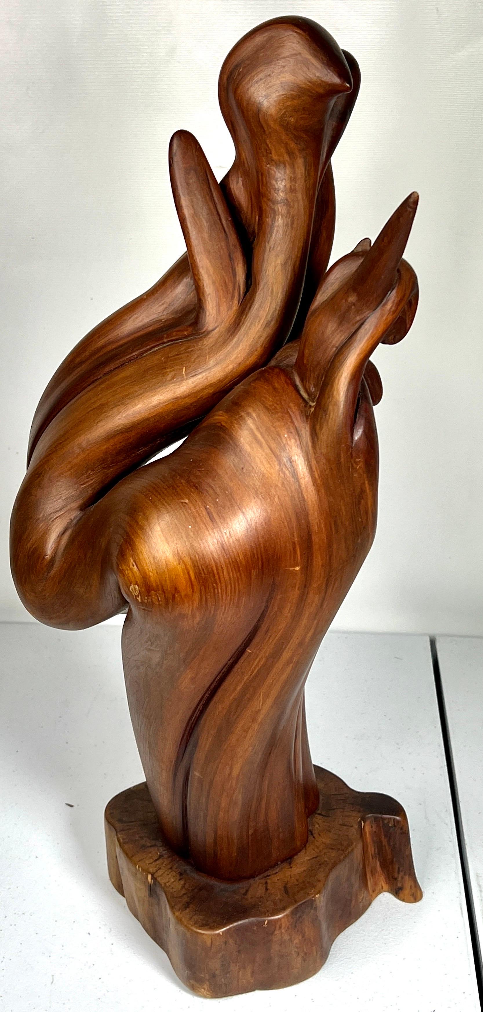 Introducing a truly remarkable piece of art: a captivating sculpture from the 1970s. Crafted with exquisite detail, this Black Walnut Abstract Bird Sculpture possesses a one-of-a-kind design that is both striking and elegant. Its timeless beauty