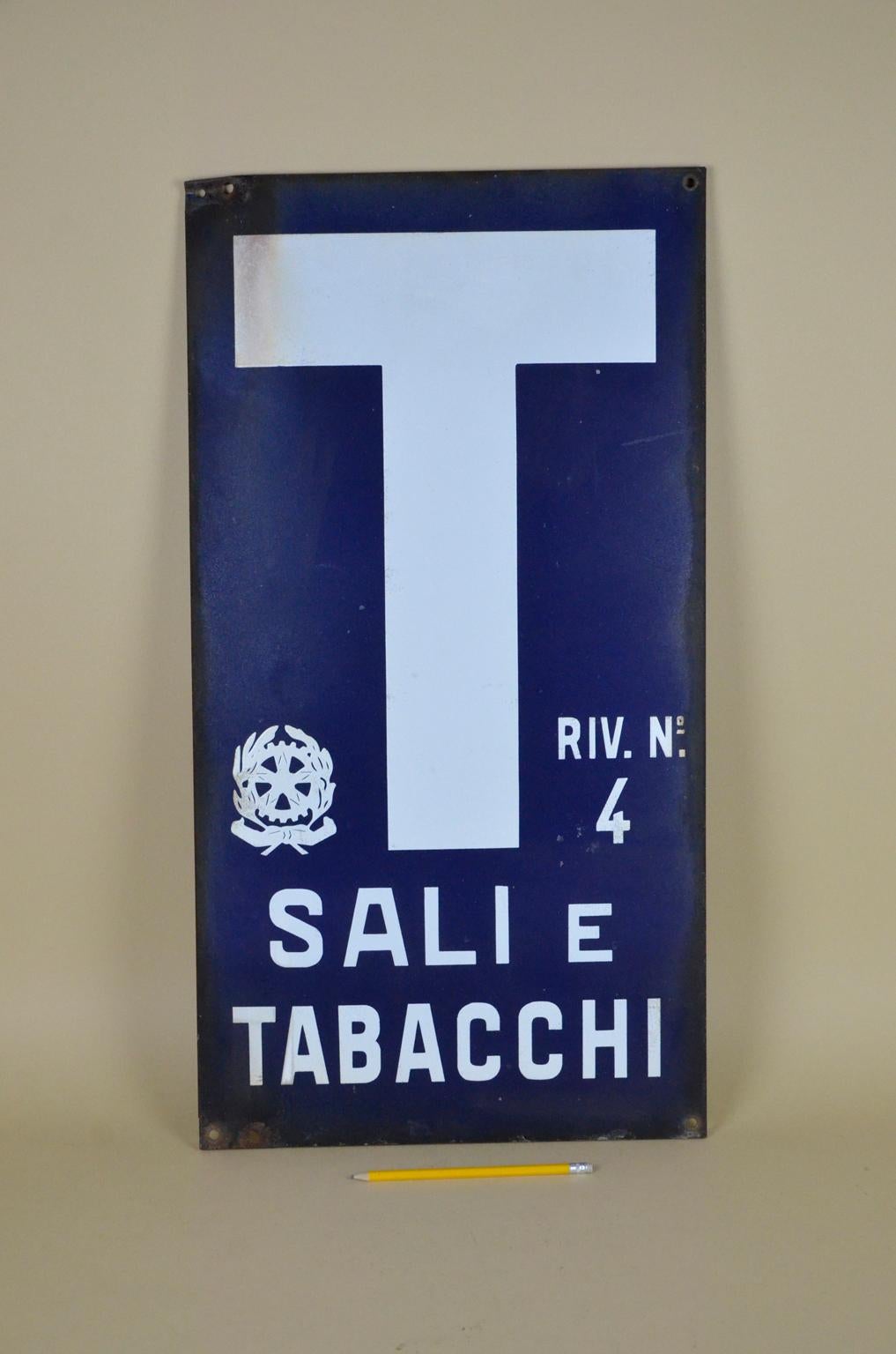 This vintage enamel tobacco sign was used by small shops in Italy selling state-monopoly products such as tobacco and cigarettes but also salt and stamps.
The number four on the right-hand side is the official license number referring to the